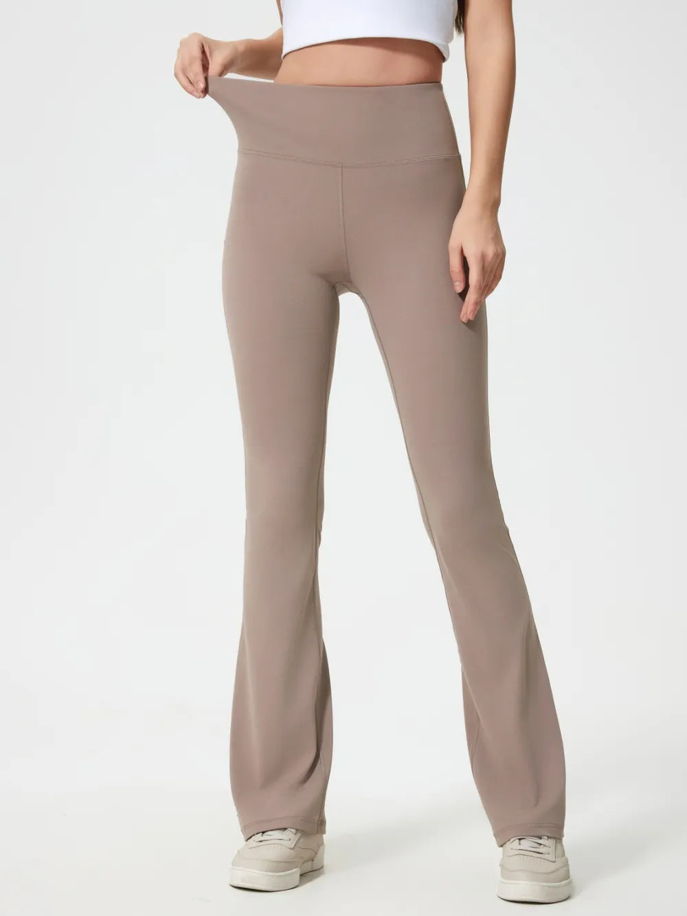 Woman wearing mocha high waist active pants front view