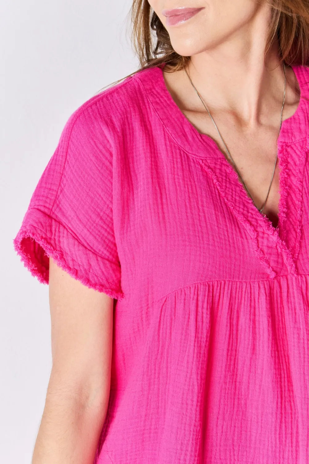 Hot pink cotton top styled with jeans on model