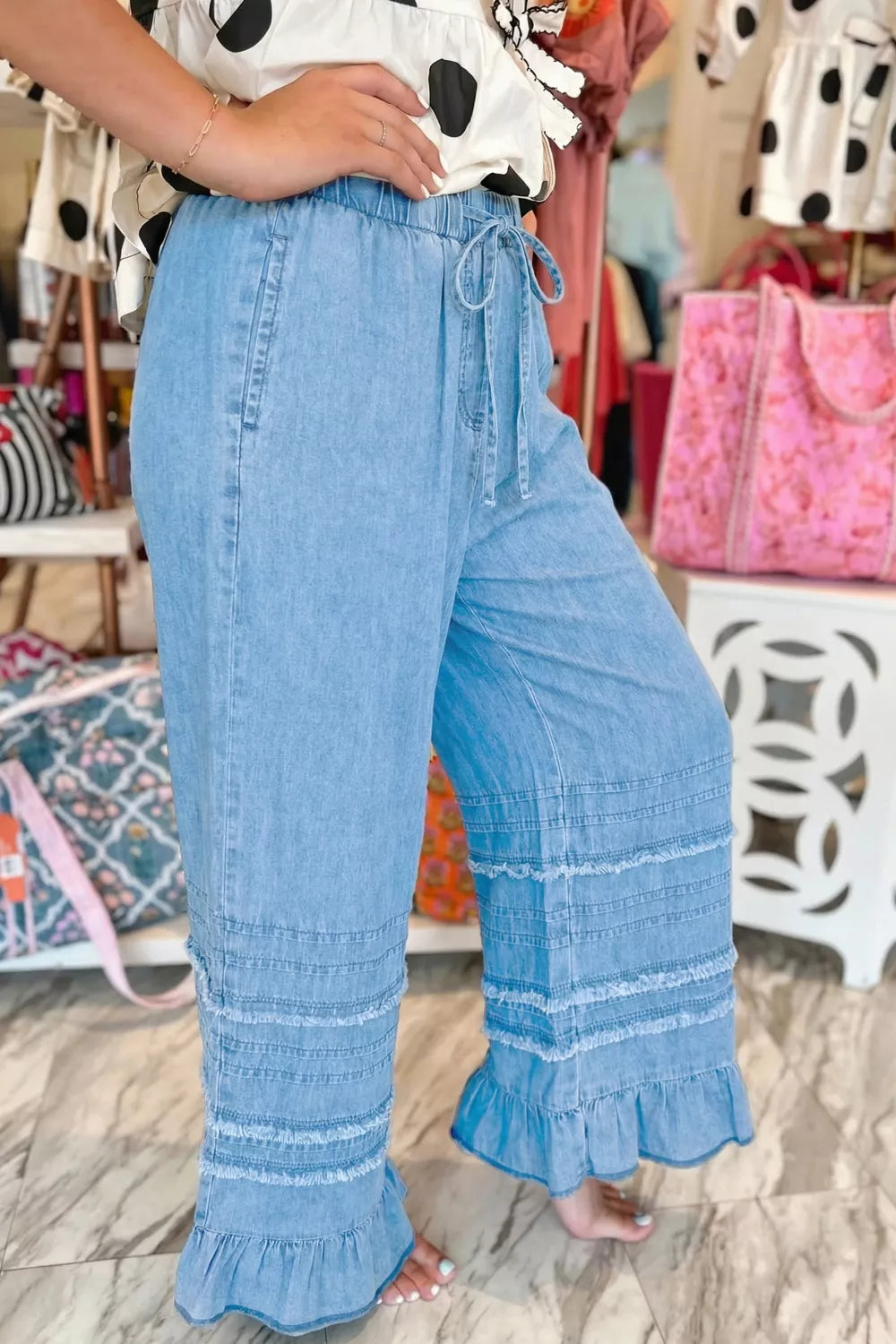 Ruffle hem chambray jeans back view with wide leg silhouette