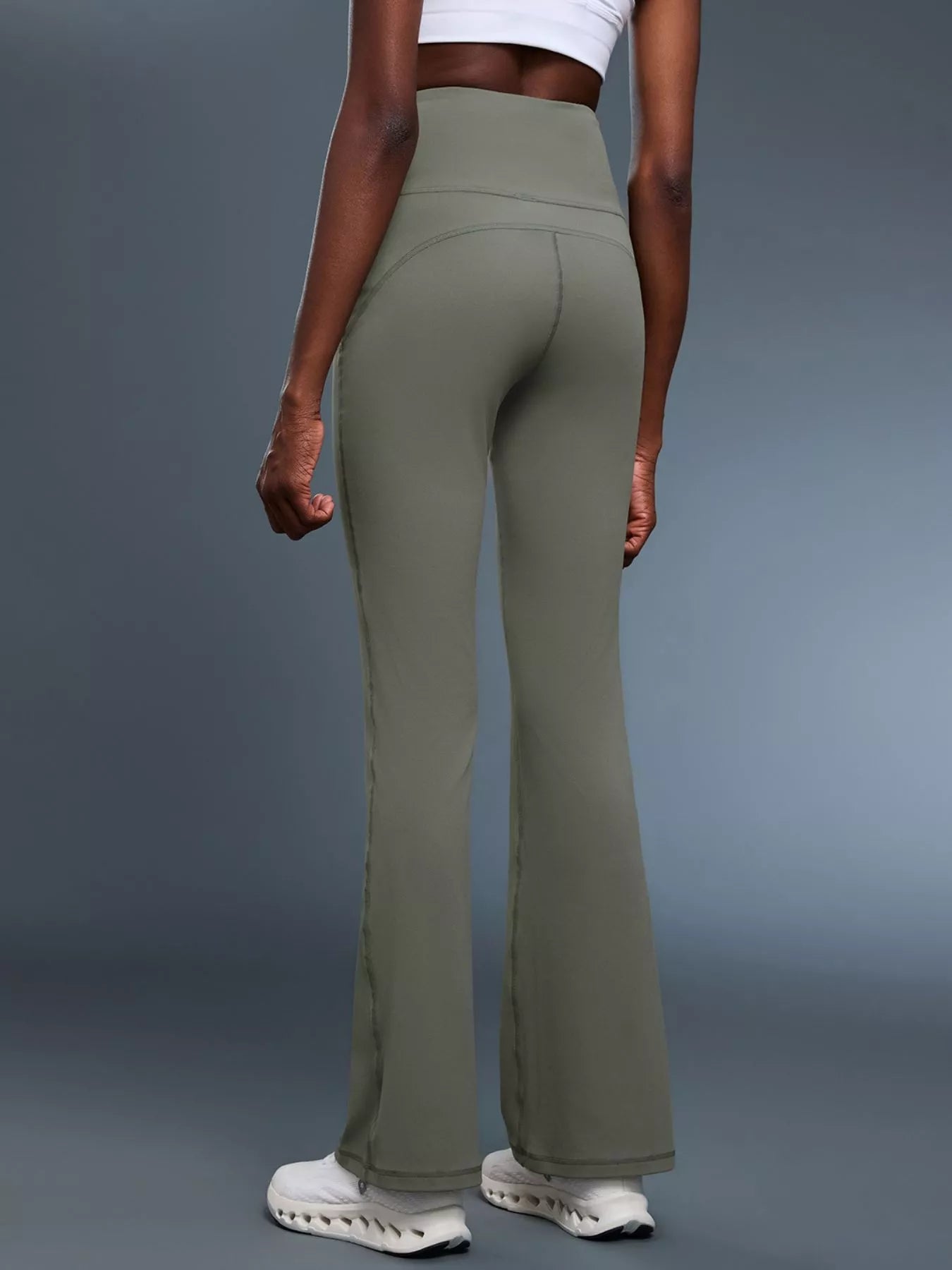 Model stretching in high waisted flare pants