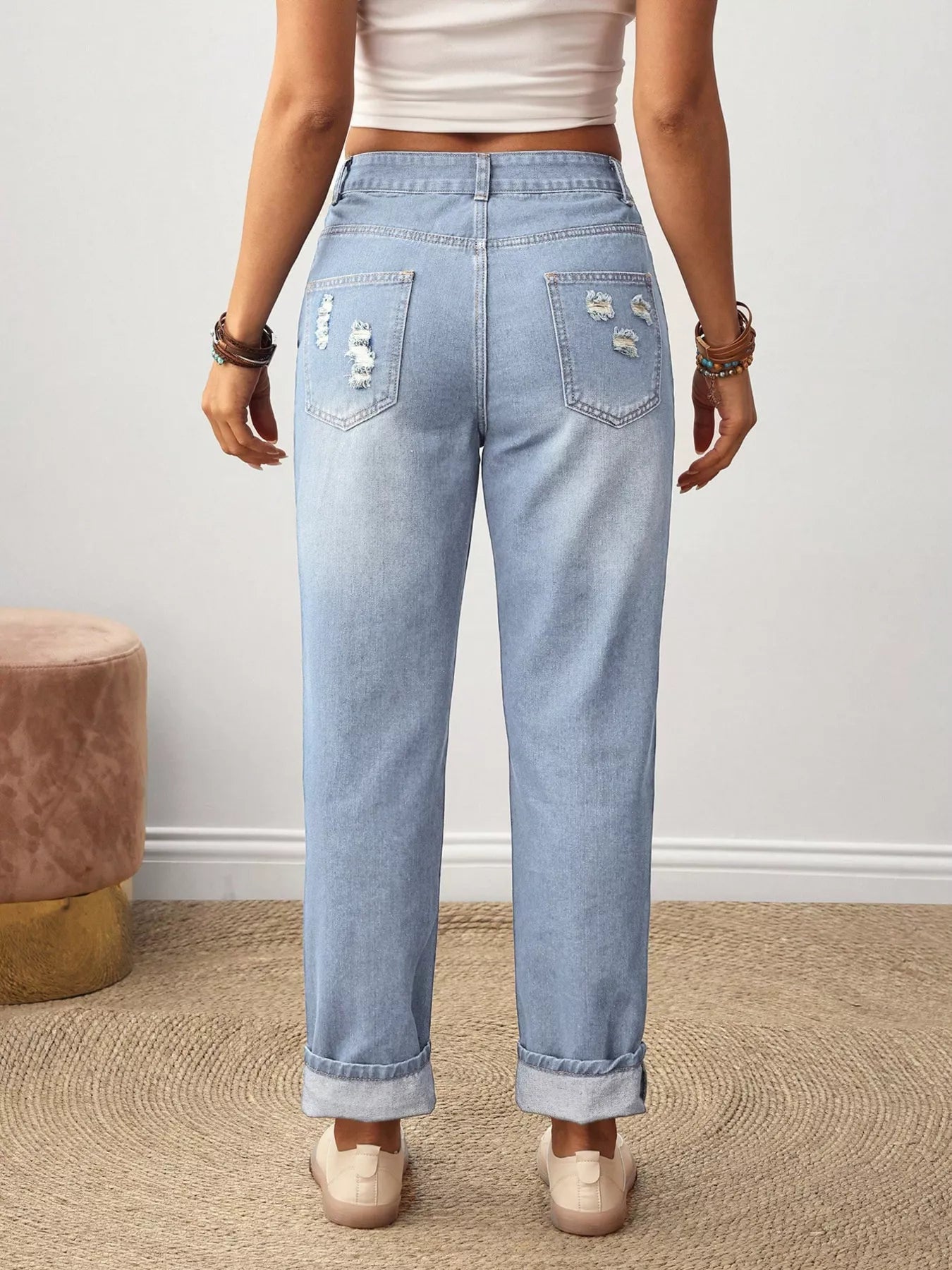 Flower embroidery detail on dusty blue distressed jeans