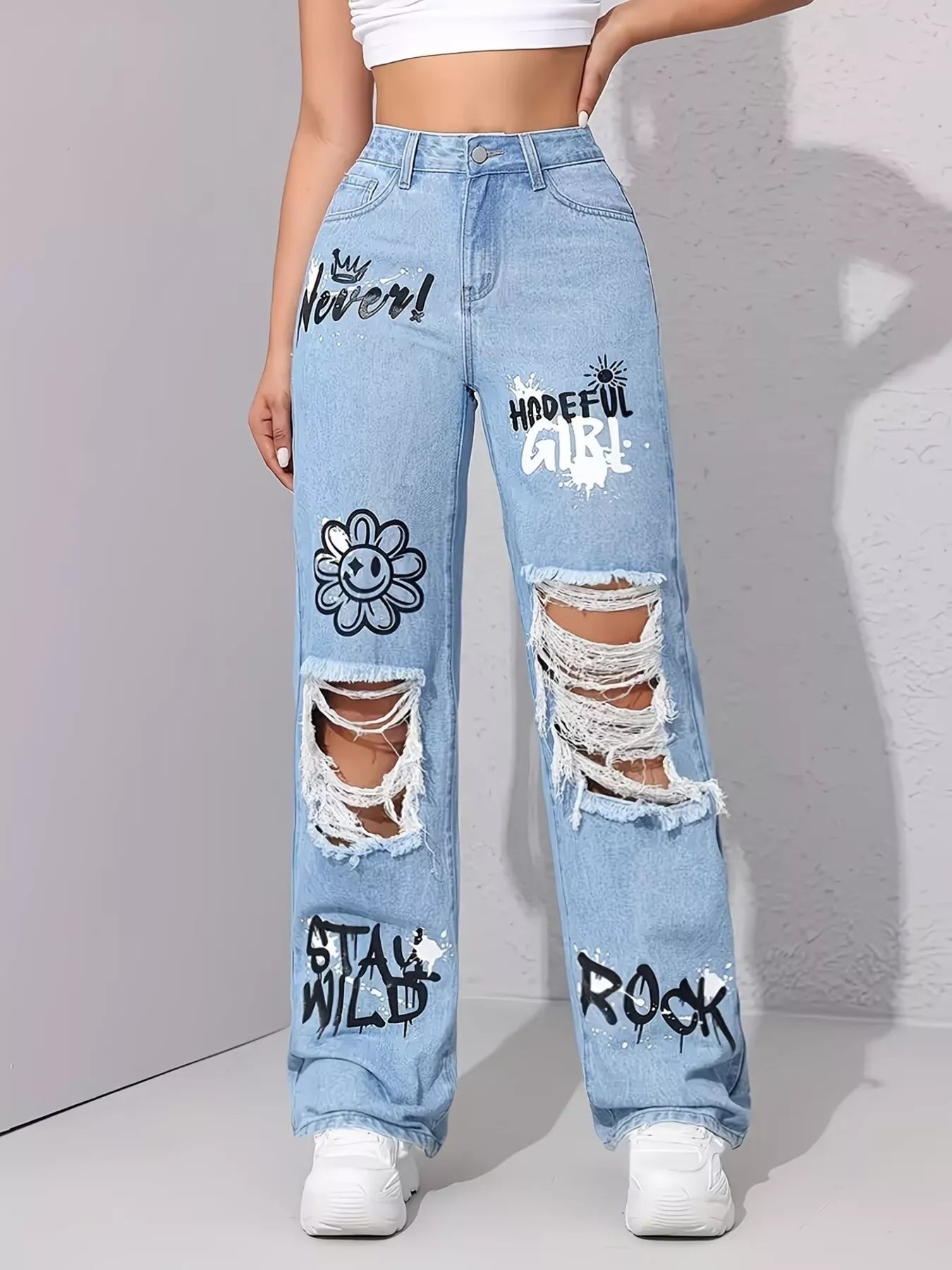 Graffiti distressing detail on light blue denim
