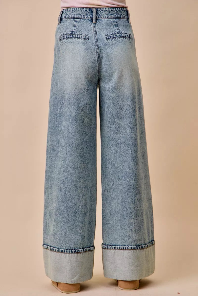 Front pleat and pocket detail on mid rise denim jeans