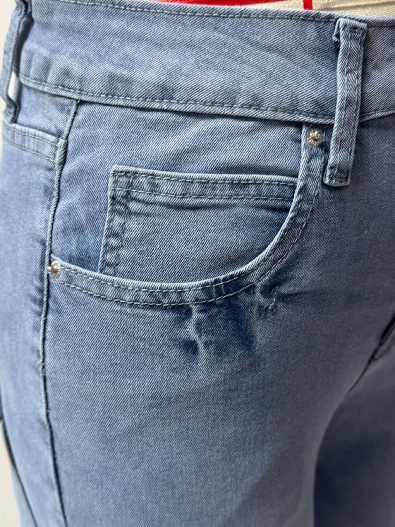 Model wearing washed blue wide leg jeans styled outfit
