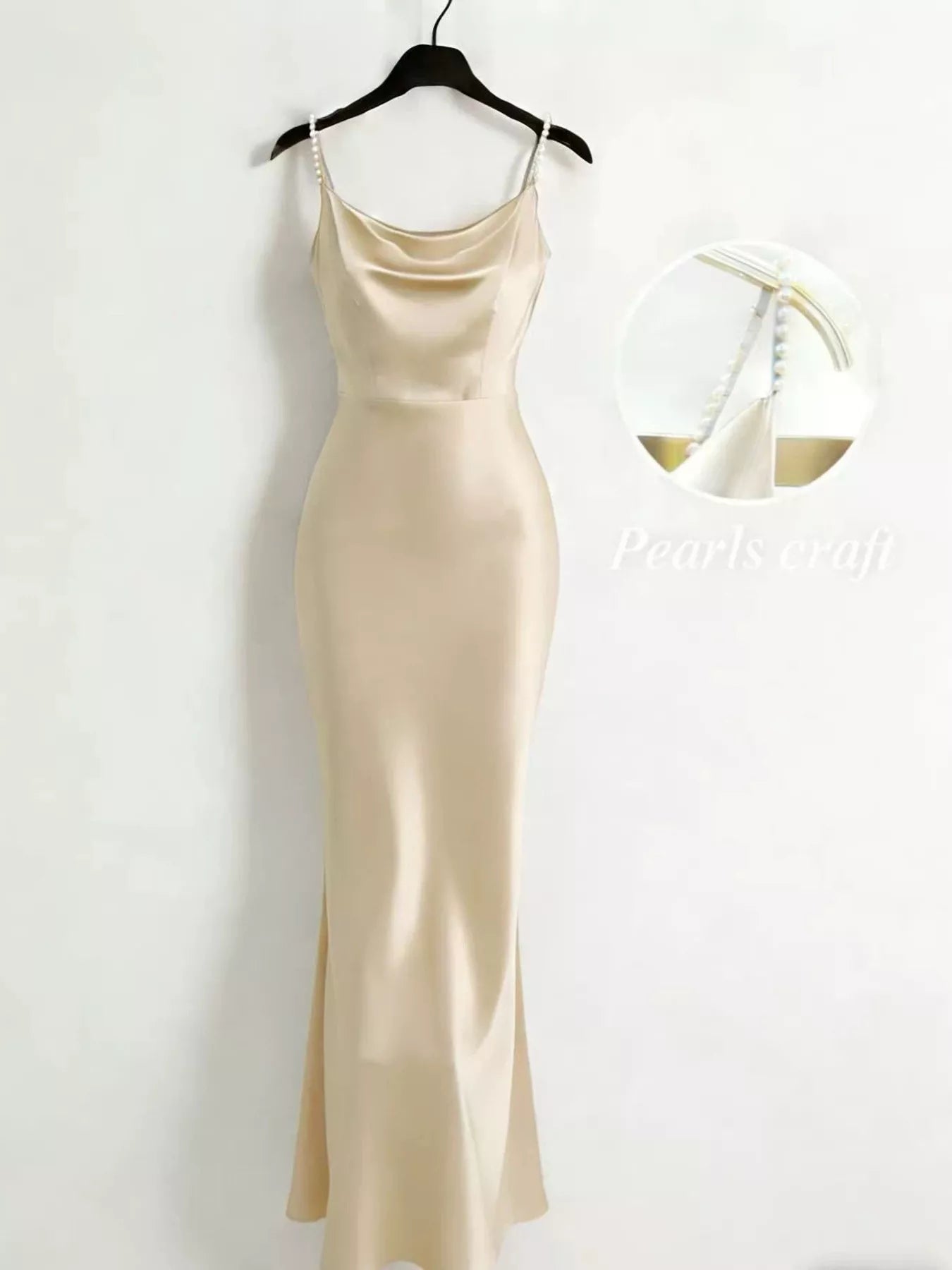 Close up of pearl strap detail on satin dress