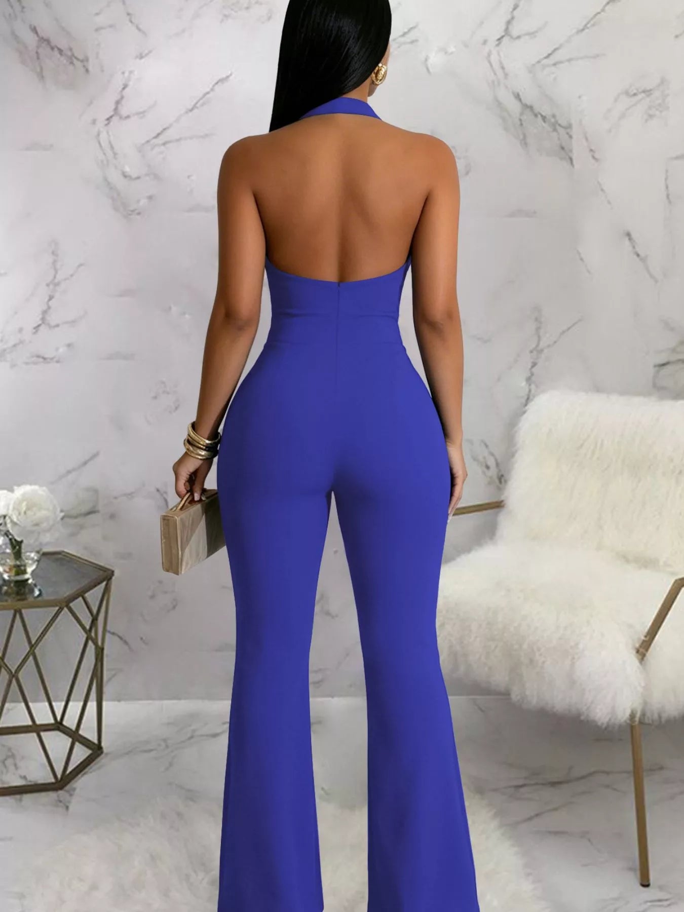 Blue cut out flare jumpsuit side view showing waist cut outs