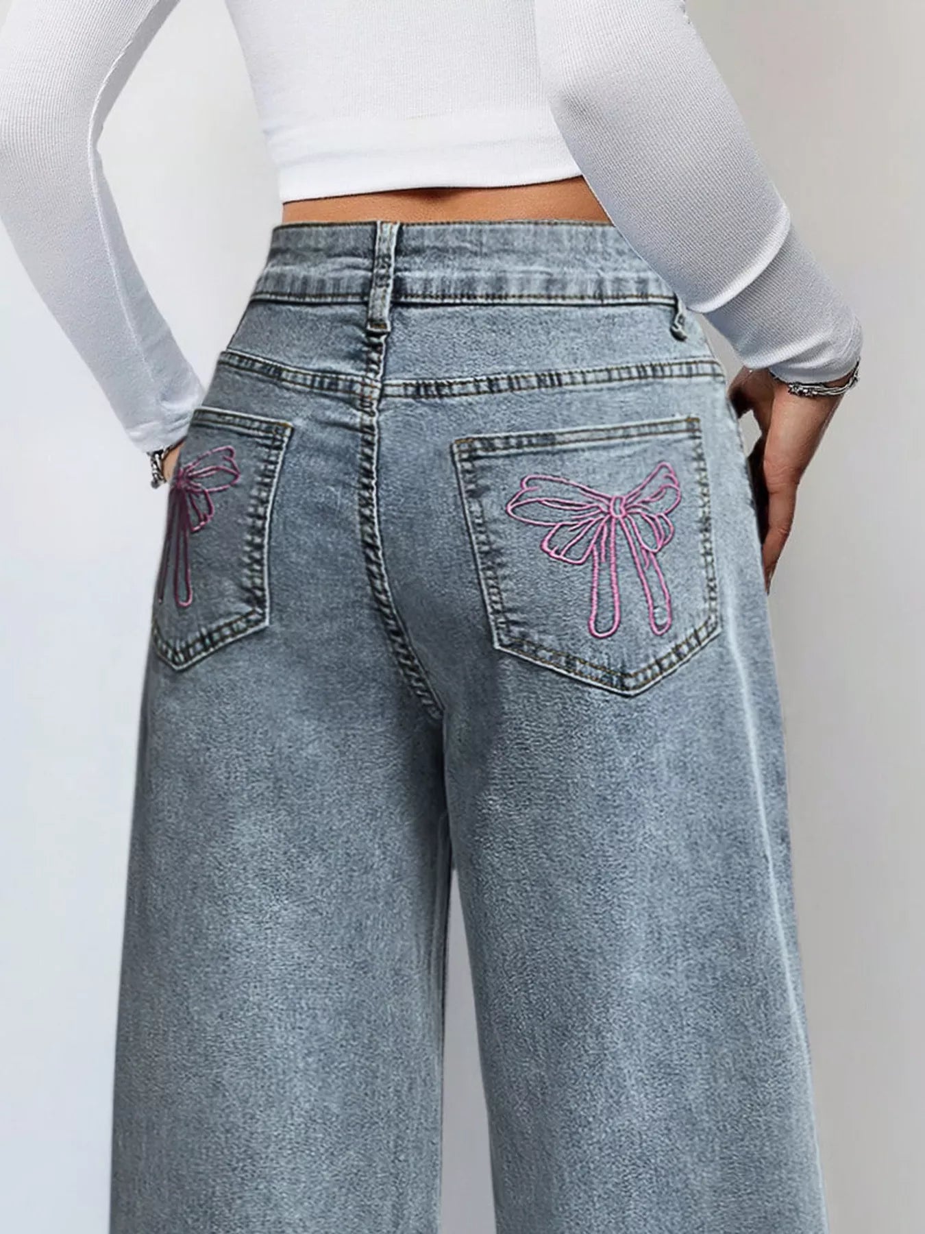 Woman wearing high waist wide leg jeans in light blue