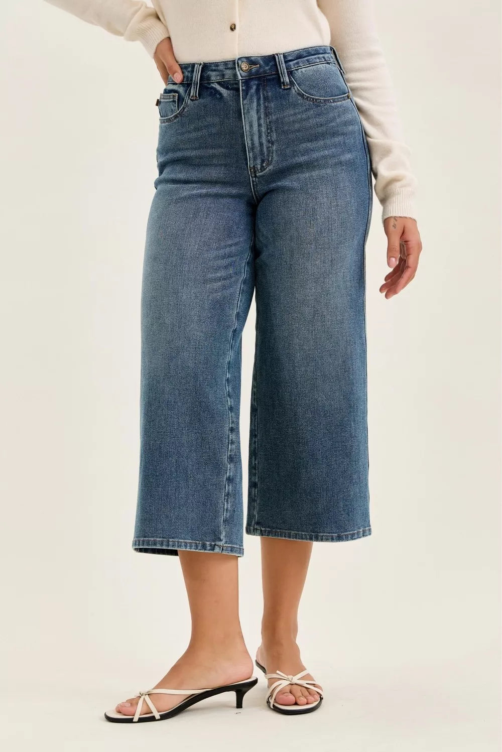 Woman wearing high waist wide crop jeans in medium wash