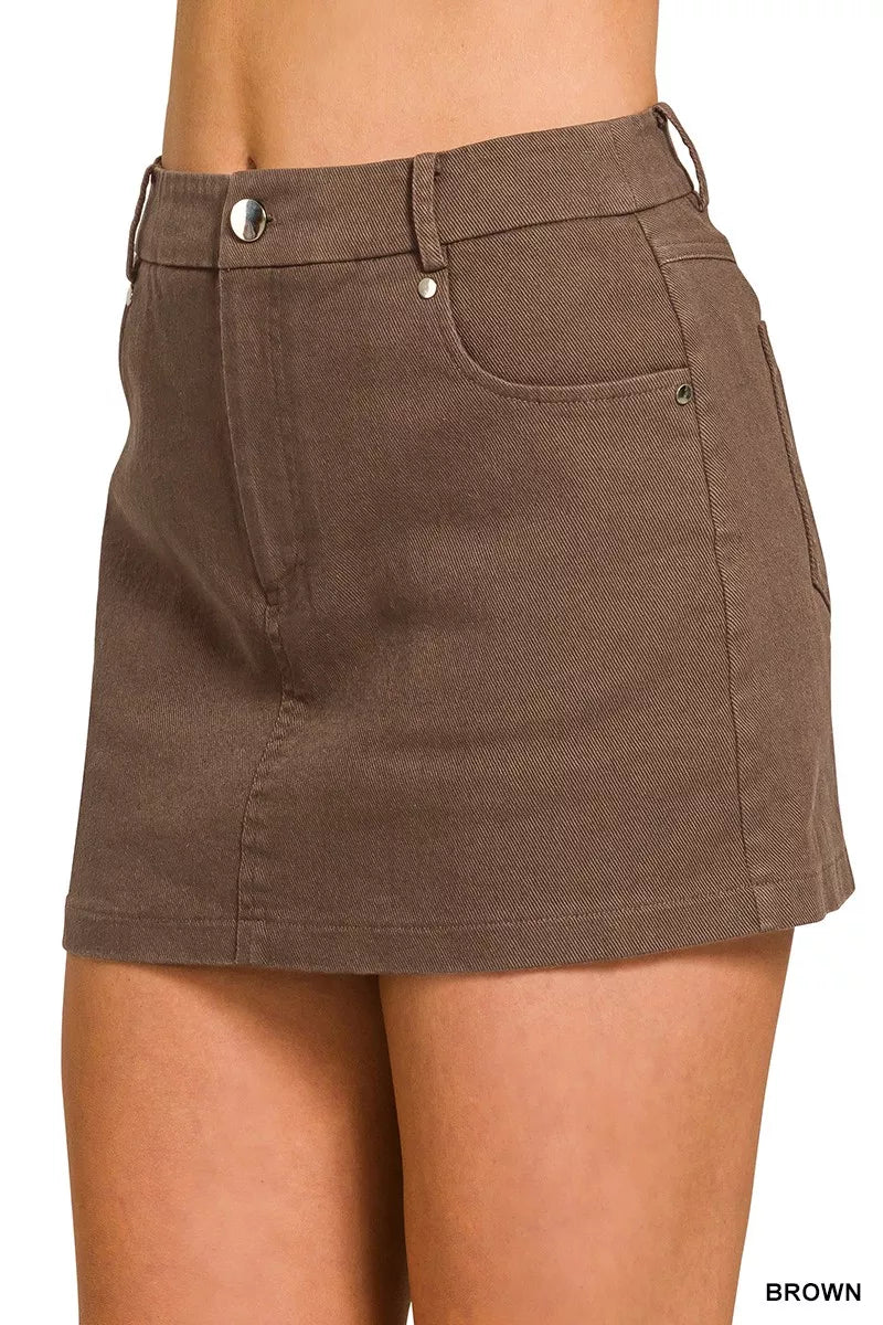 Brown twill mini skirt styled with a tucked top on model