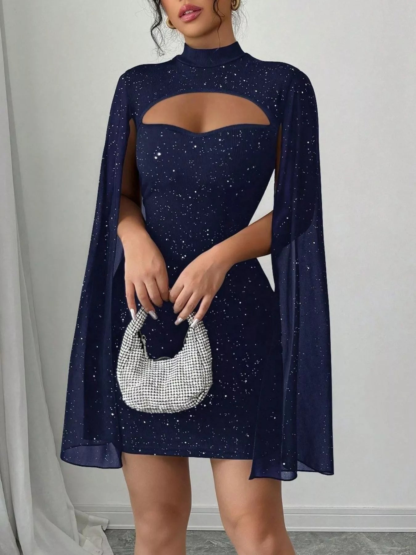 Bodycon mini dress cape sleeve detail on model