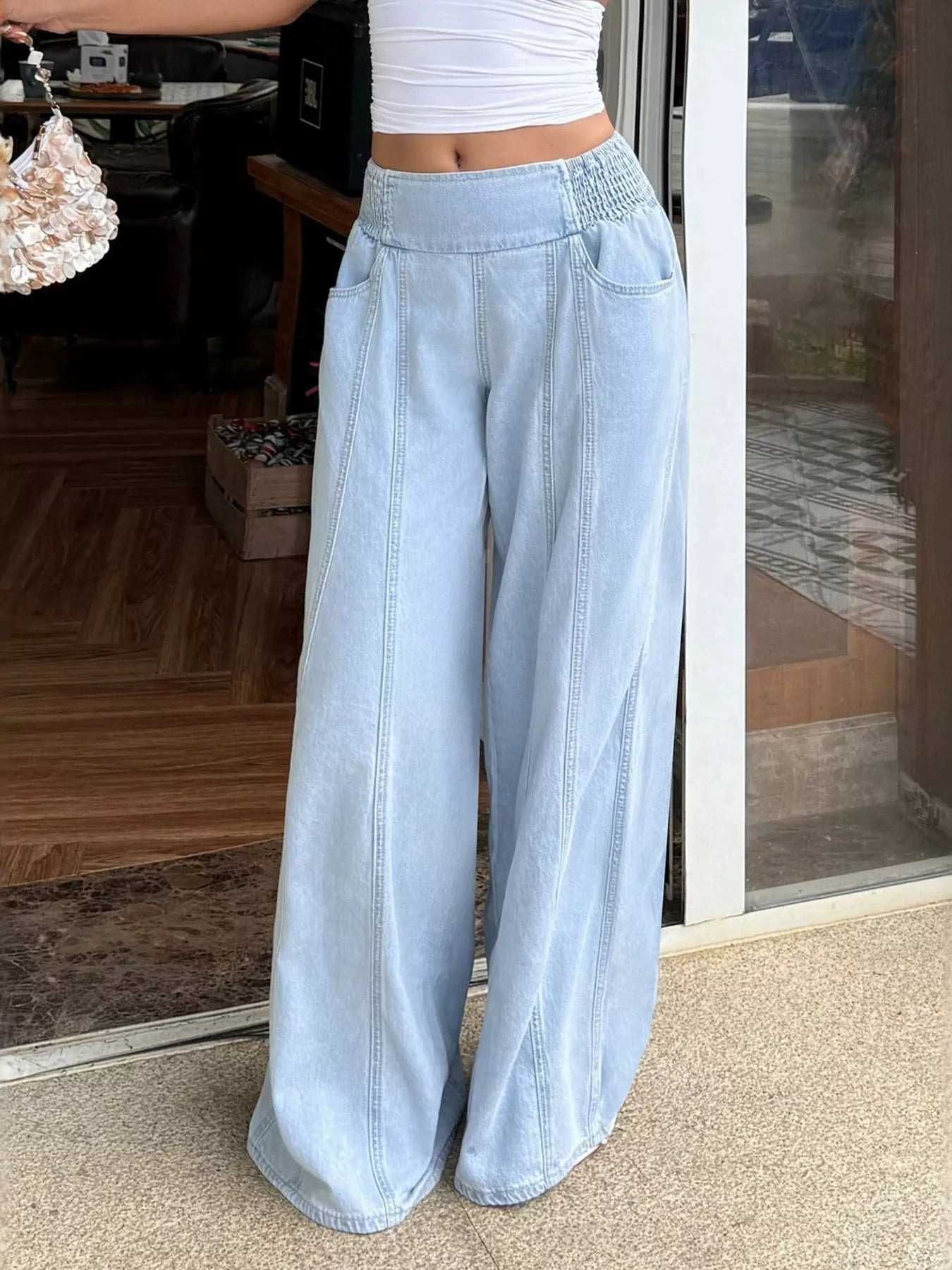 Wide leg light blue jeans styled with top