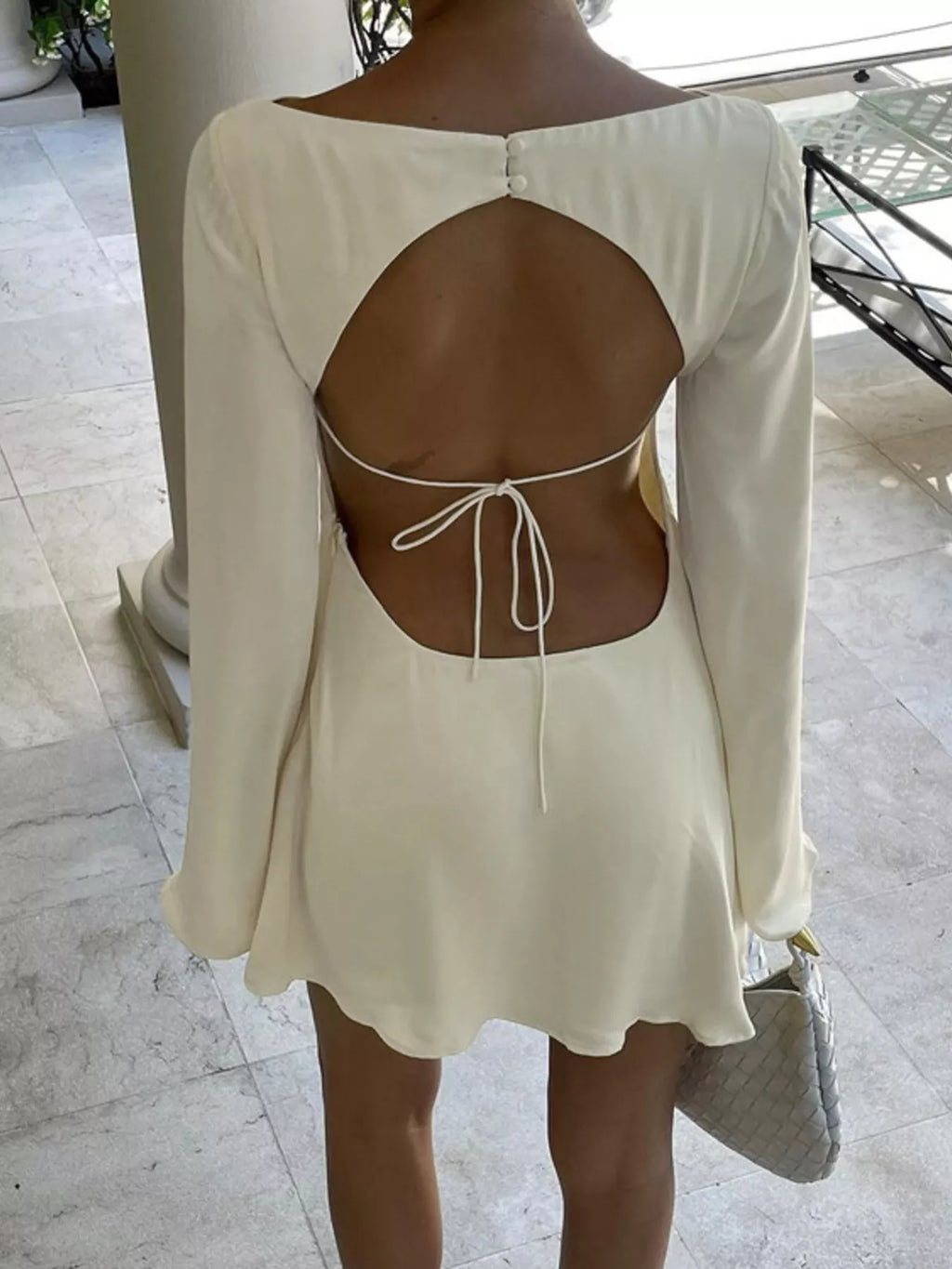 Backless mini dress shown on model