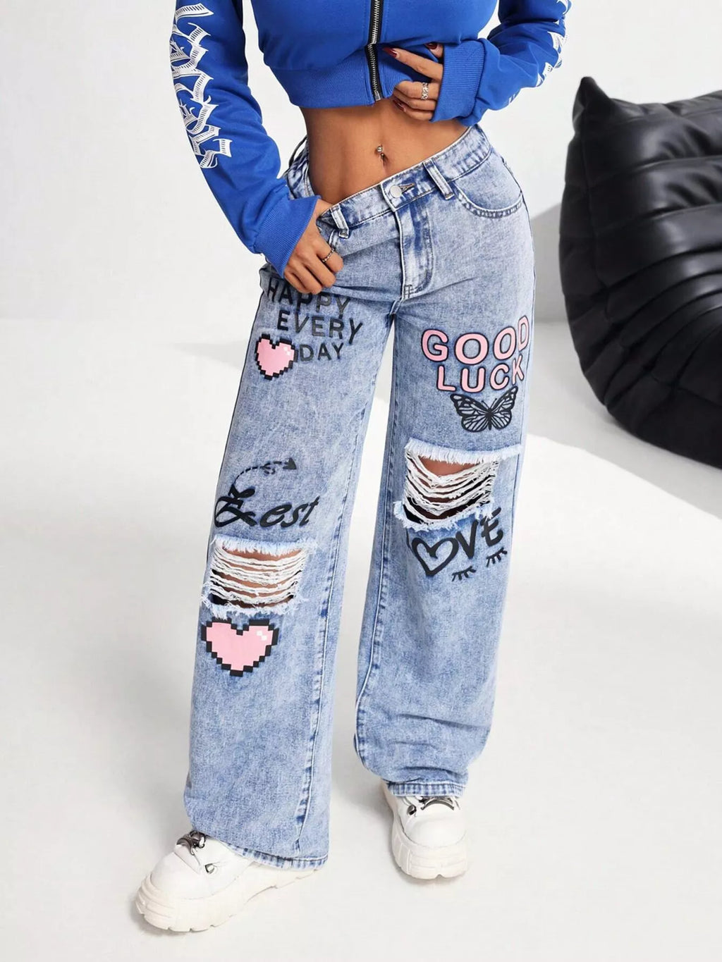 Woman wearing graffiti print ripped wide leg jeans