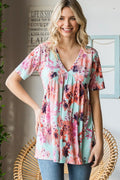 Woman wearing mint floral V neck babydoll blouse front view