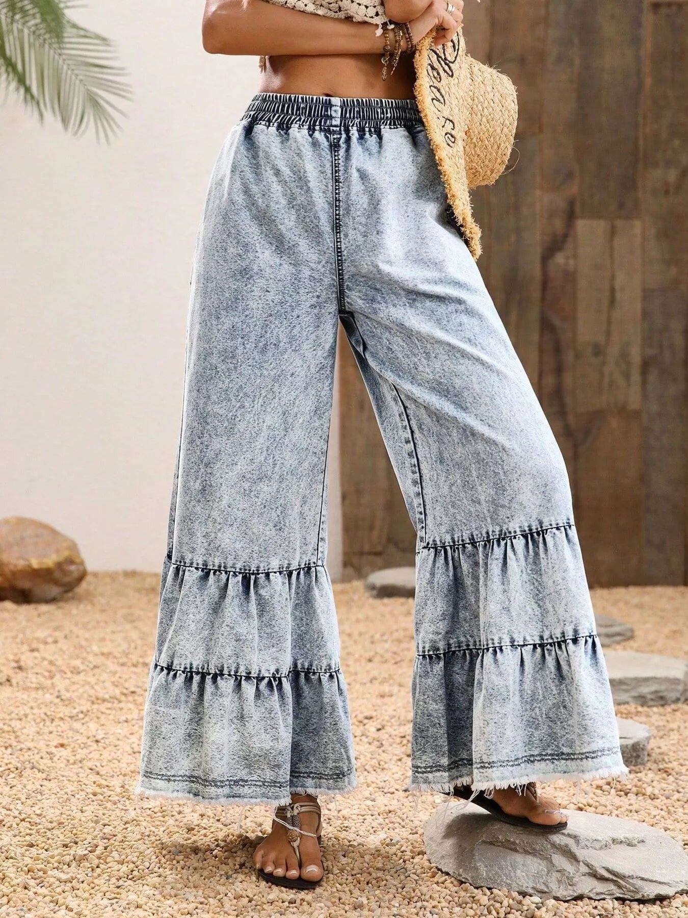 Model wearing white raw hem flare jeans full length view