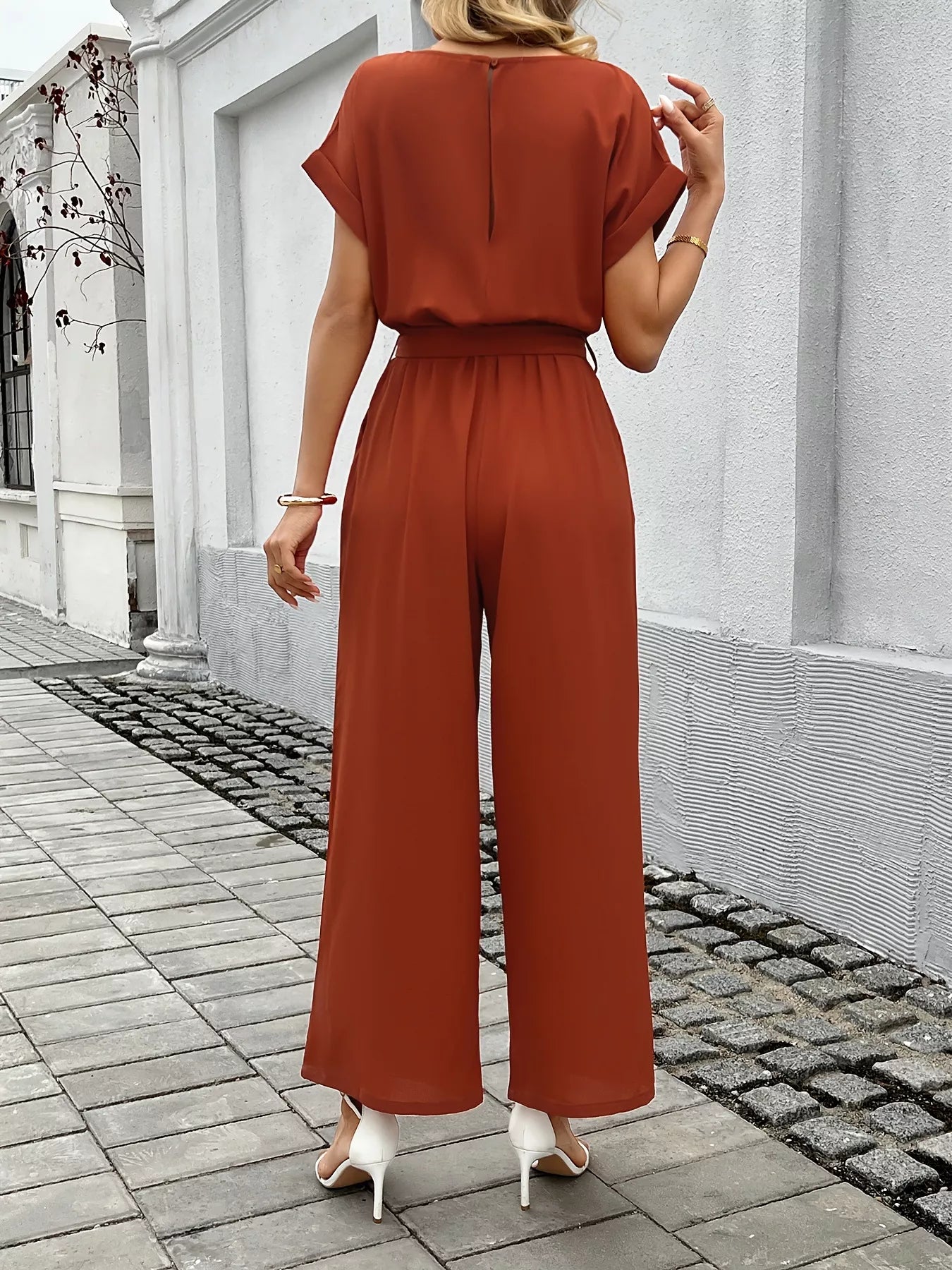 Wide leg jumpsuit side view showing flowing legs
