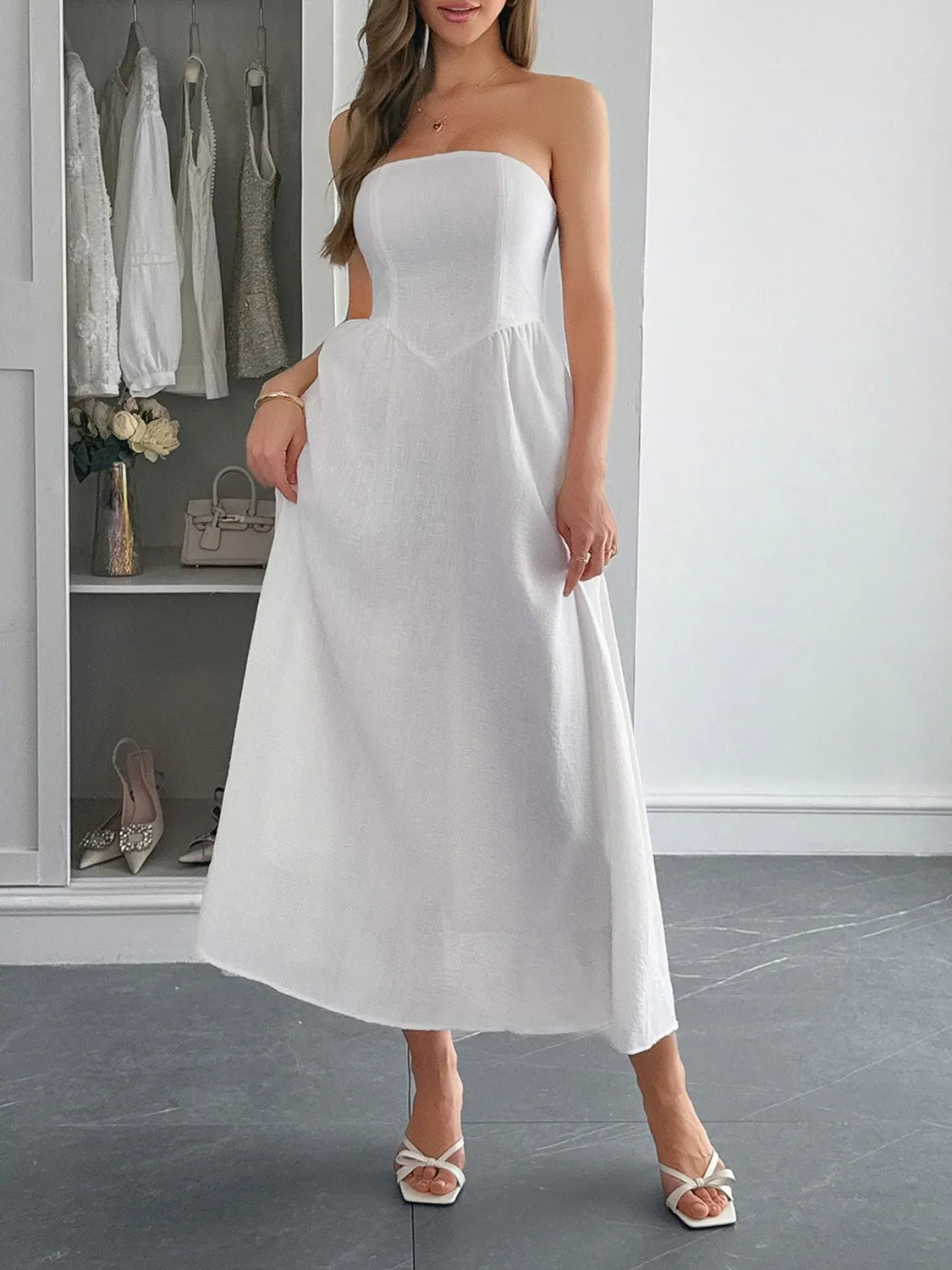 White midi dress with pockets on model