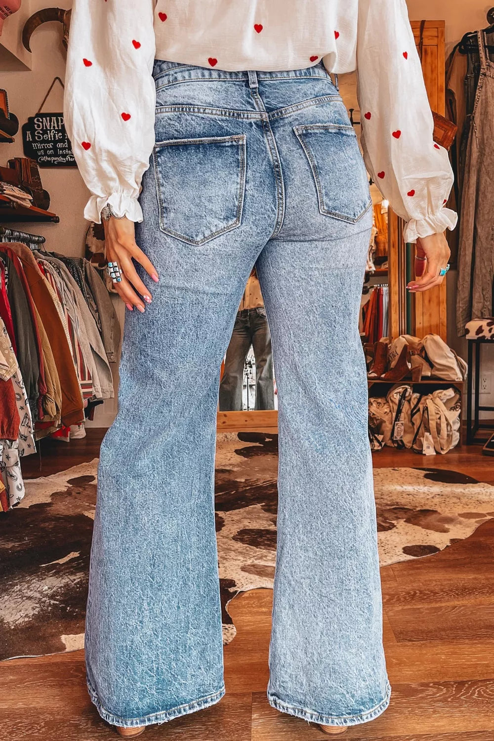 Woman wearing acid wash flare jeans
