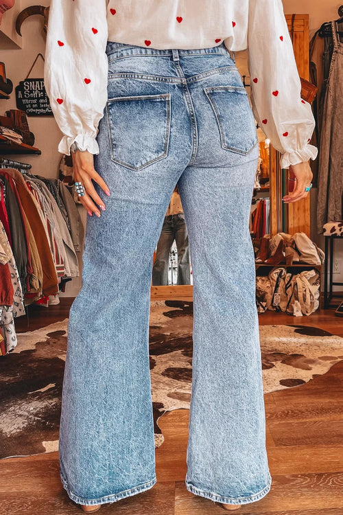 Woman wearing acid wash flare jeans