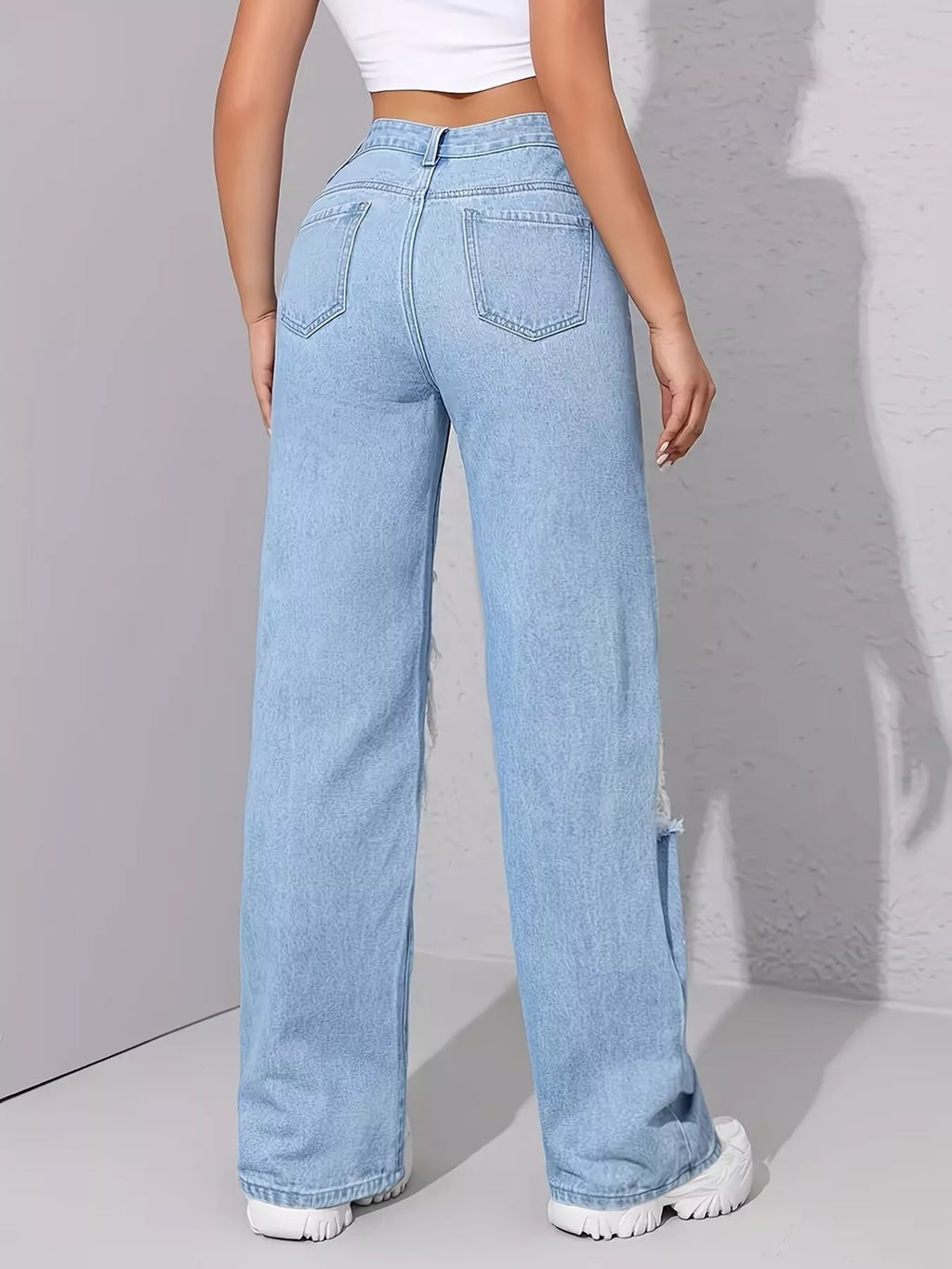 Woman wearing graffiti distressed wide leg jeans