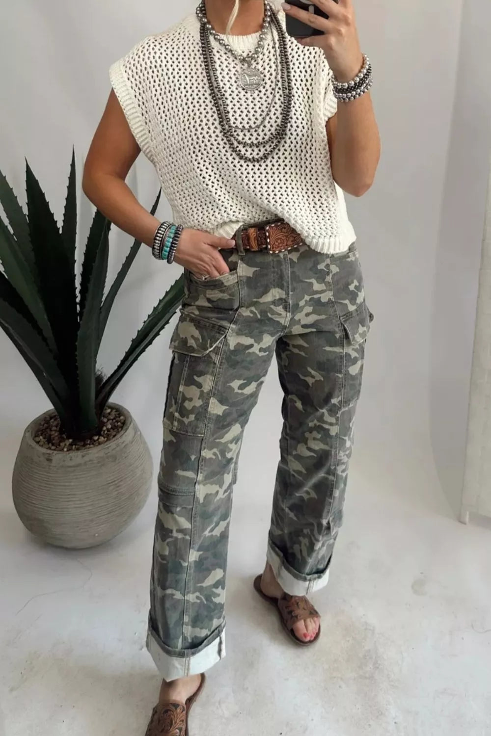 Side view of green camo cargo pants with pocket detail