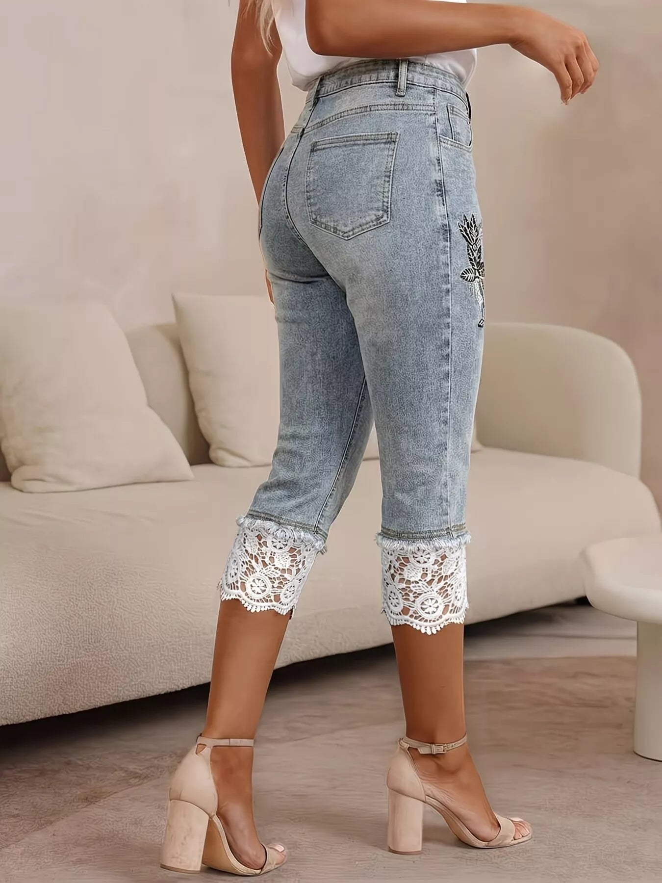 Side view of lace trimmed capri jeans cropped length