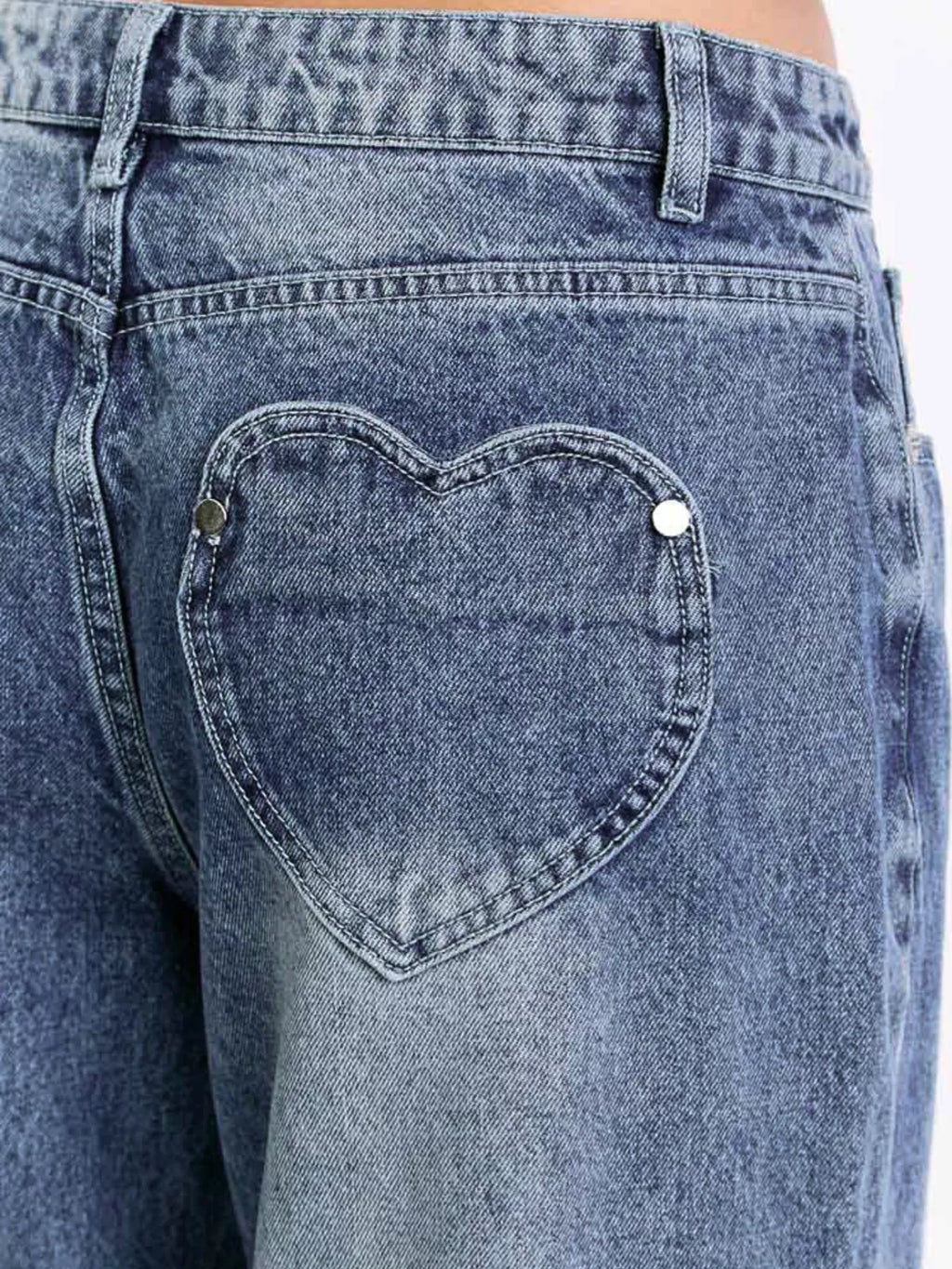 Button closure and waistband detail on wide leg jeans