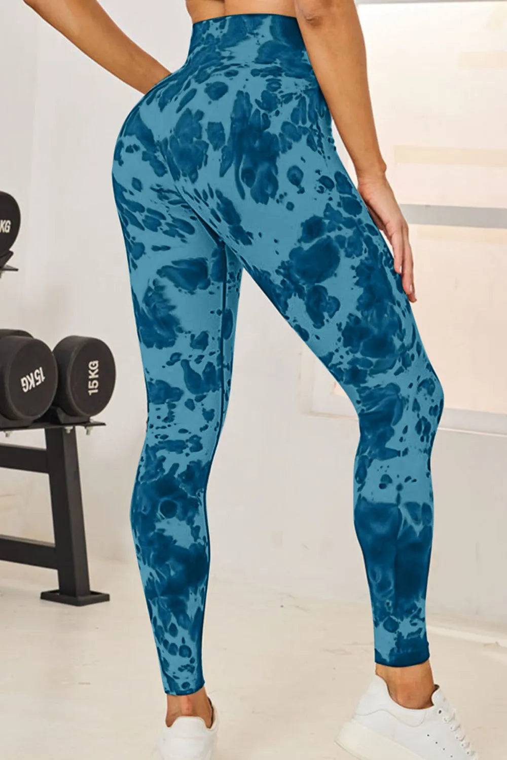 Model wearing tie dye high waist active leggings