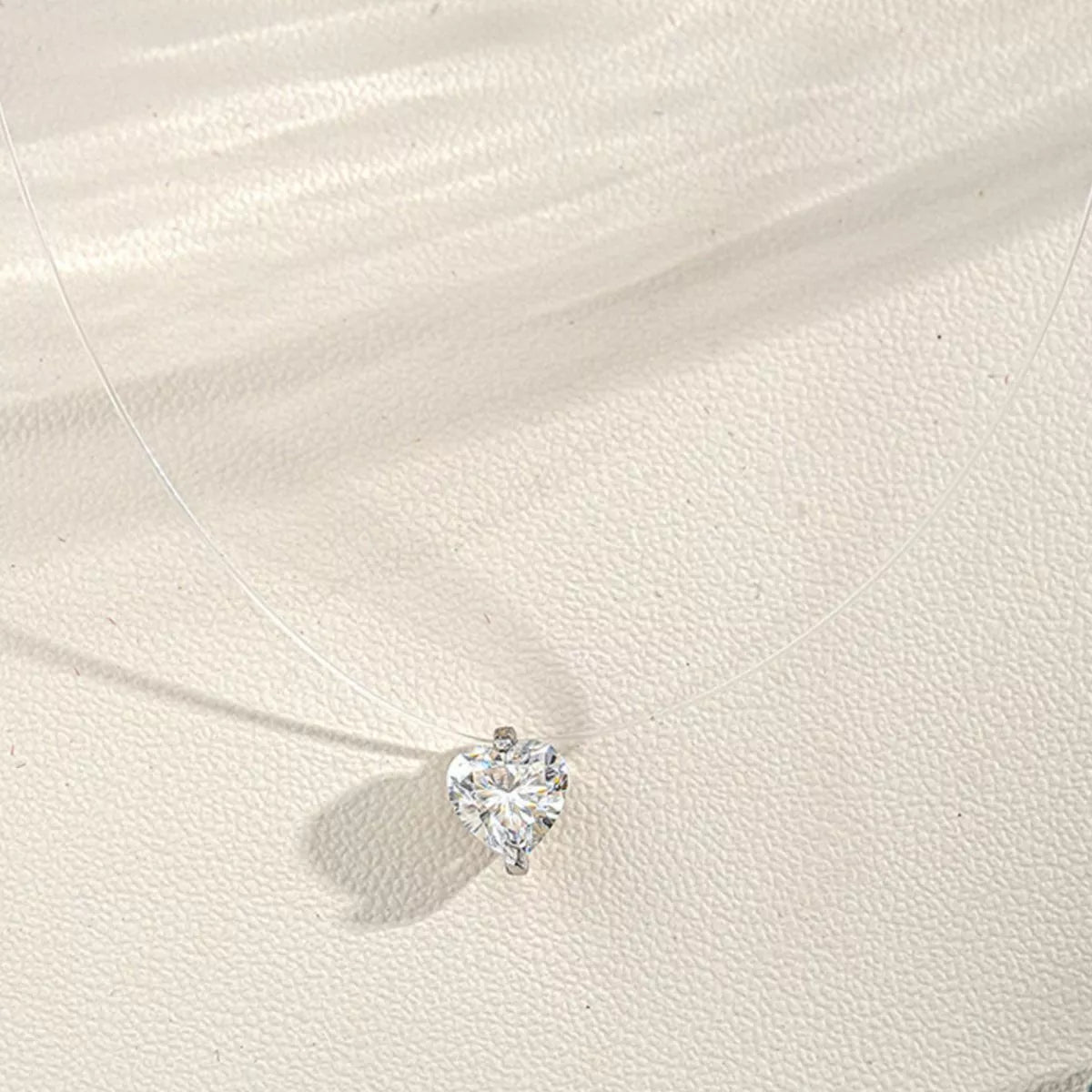 Moissanite heart necklace angled sparkle view