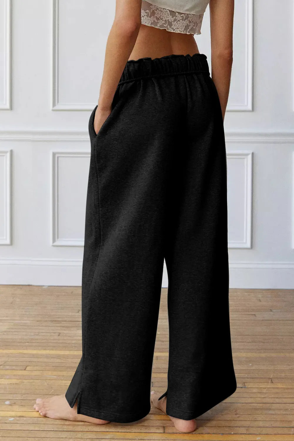 Drawstring waist detail on black wide leg pants