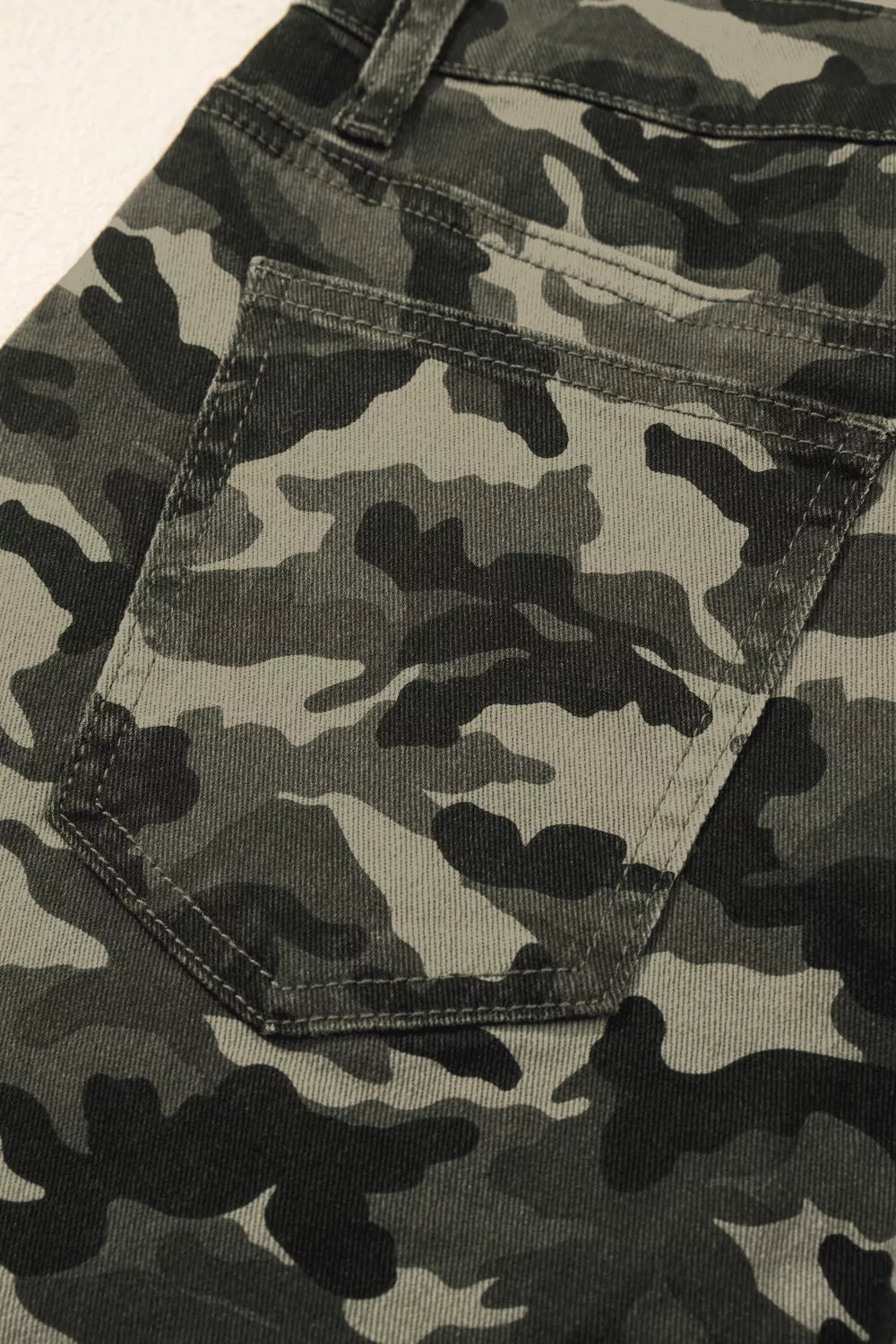 Model wearing camo cargo denim pants street style look