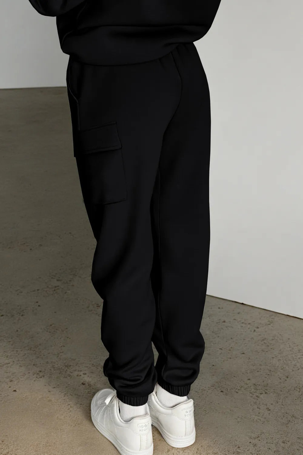 Black jogger pants back view on model