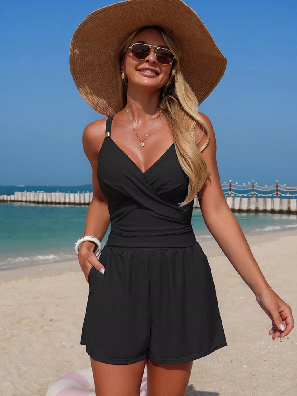 Black spaghetti strap one piece swimsuit on model