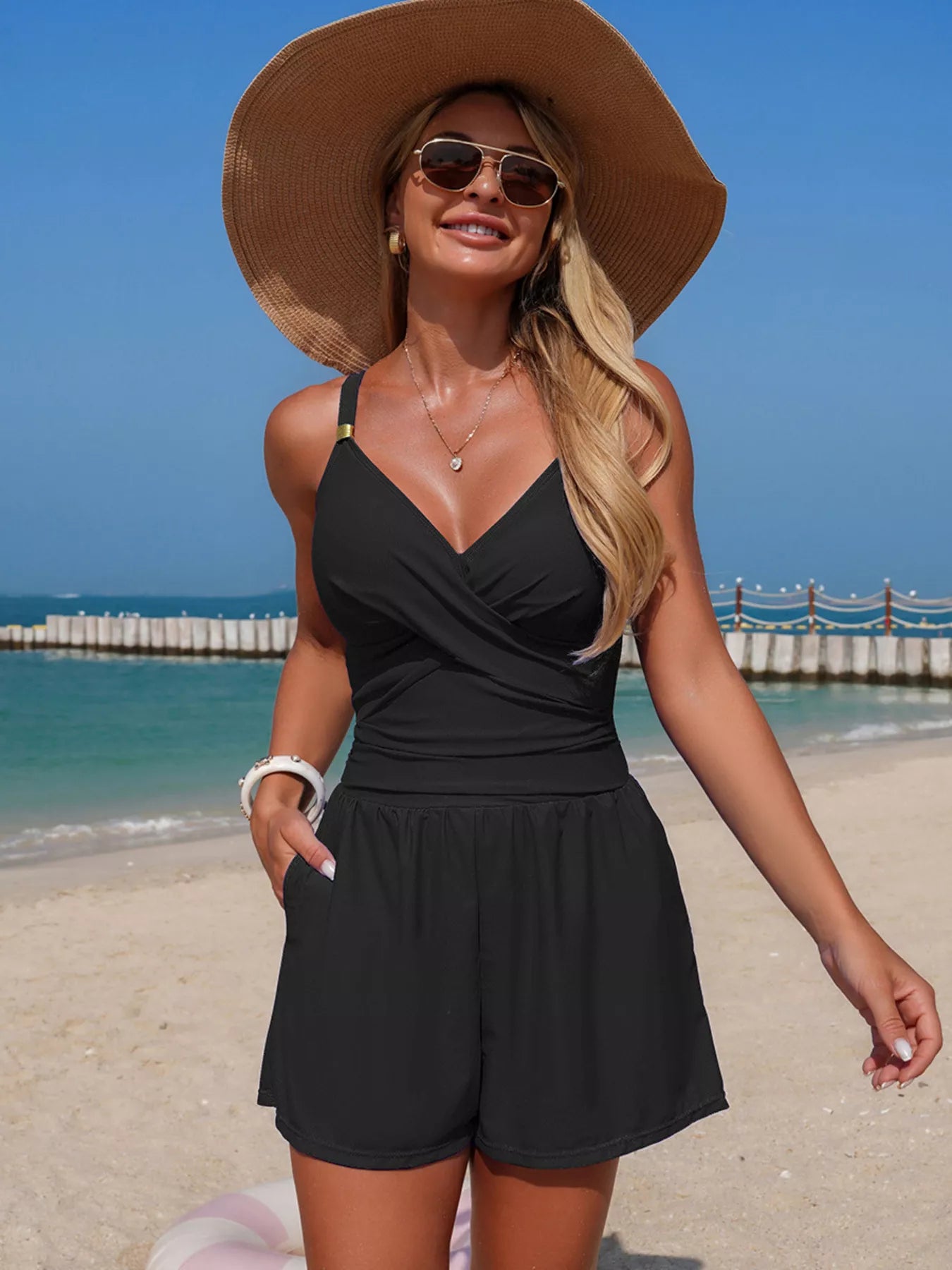 Black spaghetti strap one piece swimsuit on model
