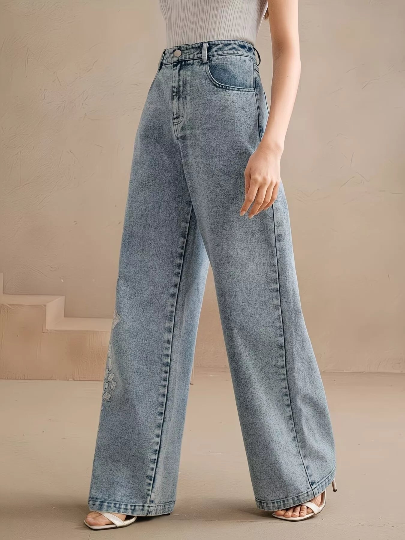 Wide leg silhouette of embroidered blue jeans