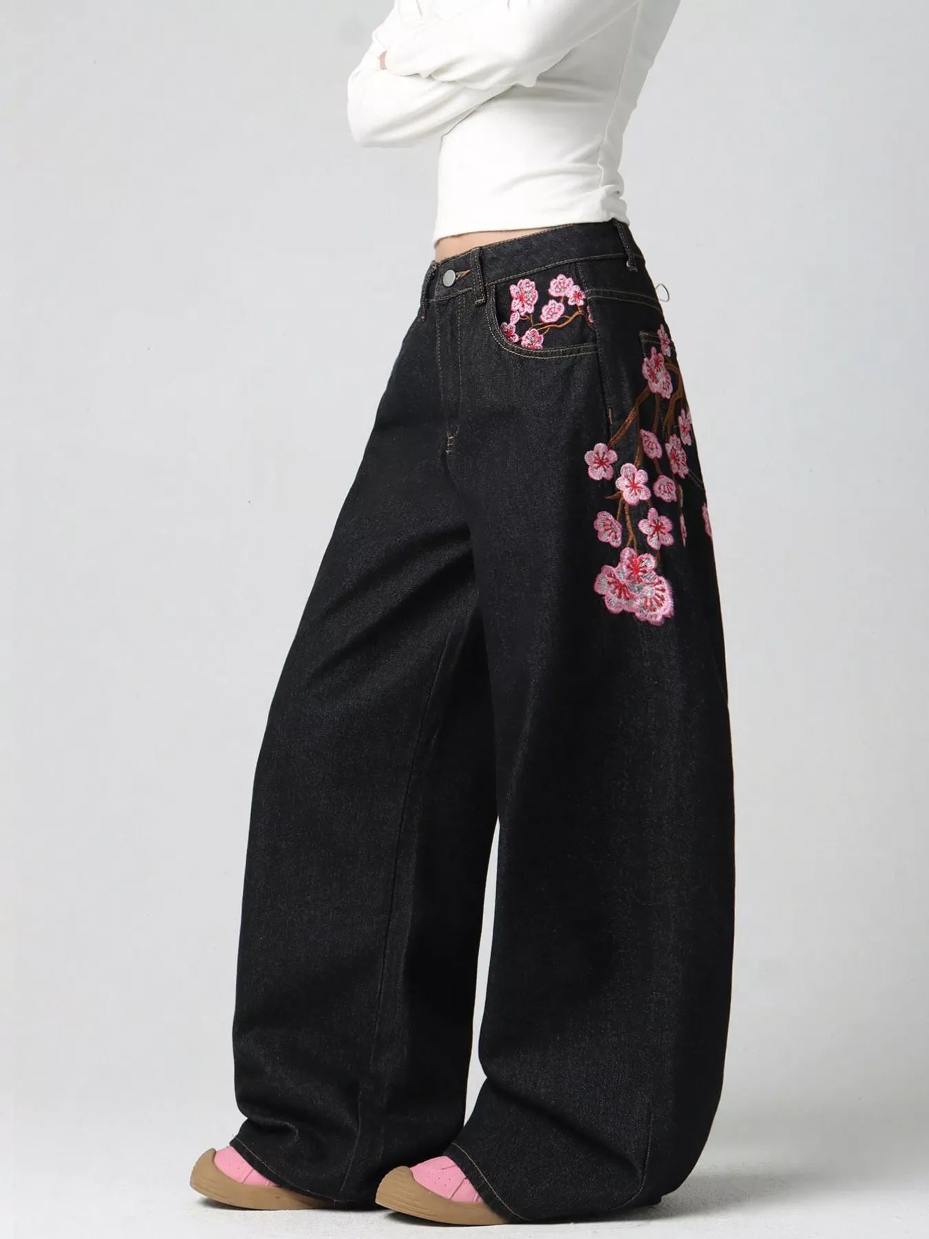 Embroidery detail on black wide leg jeans