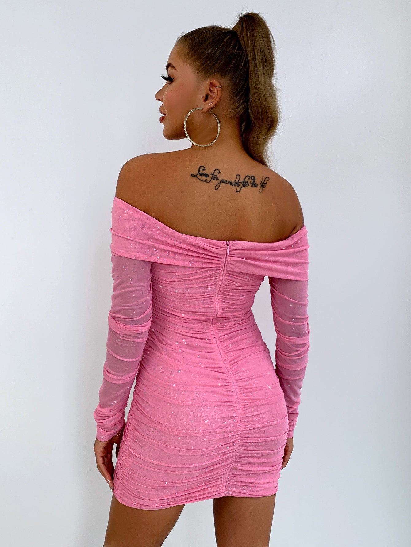 Pink glitter off shoulder dress on model