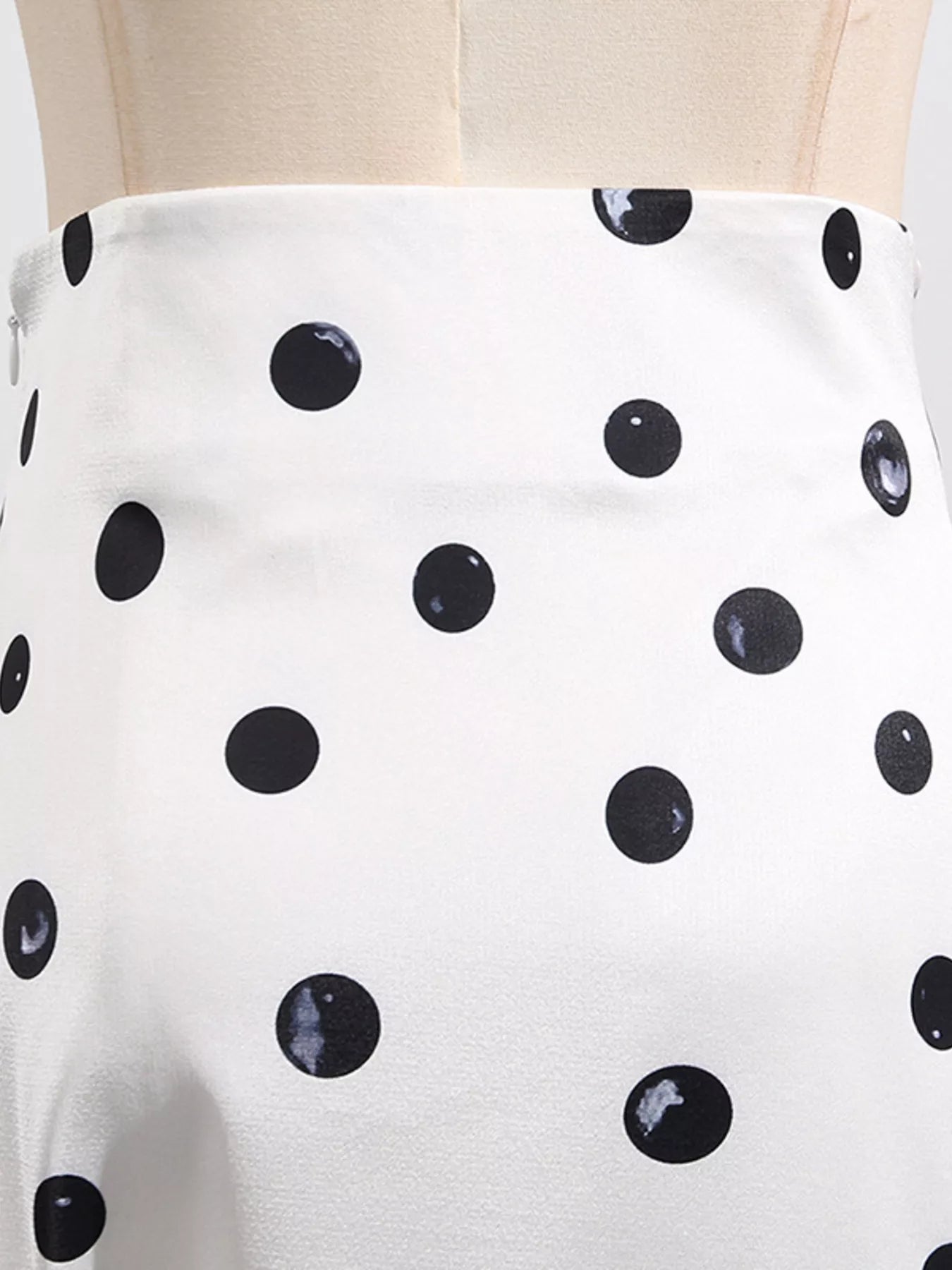 Ruffle hem detail on beige midi skirt