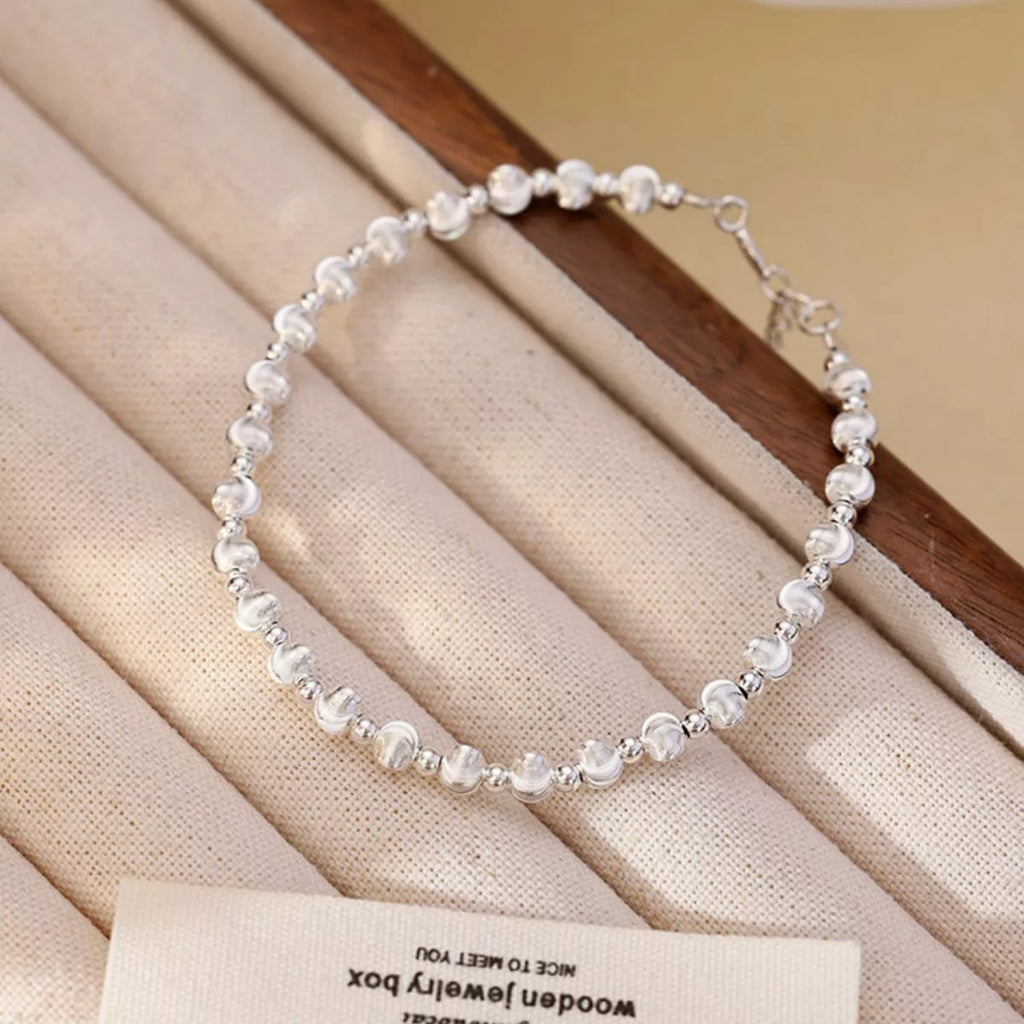 Dainty silver beaded bracelet close up sparkle