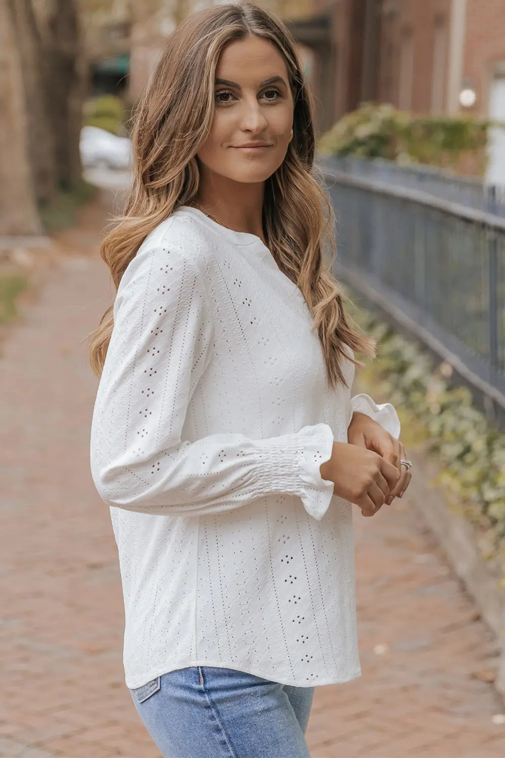 Model wearing white openwork flounce sleeve blouse