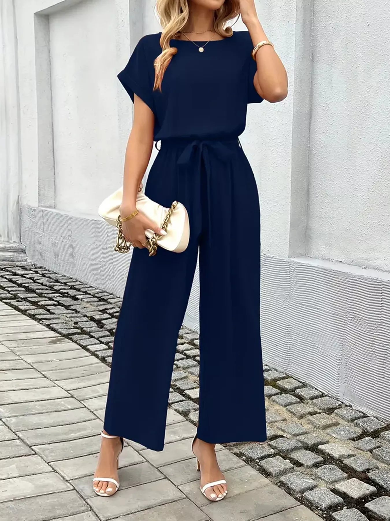 Belted jumpsuit in dark blue front view