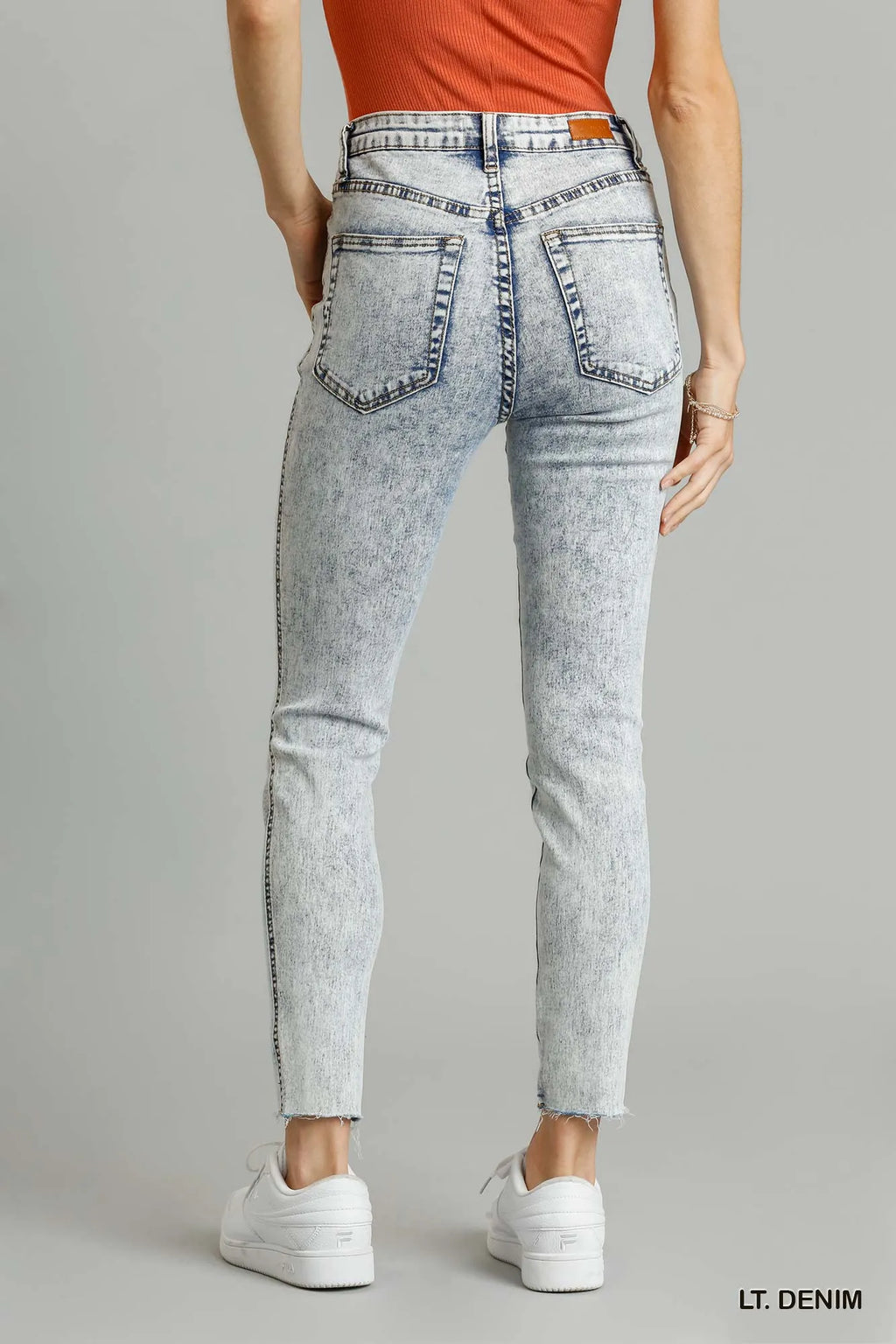 Distressed skinny jeans raw unfinished hem close up