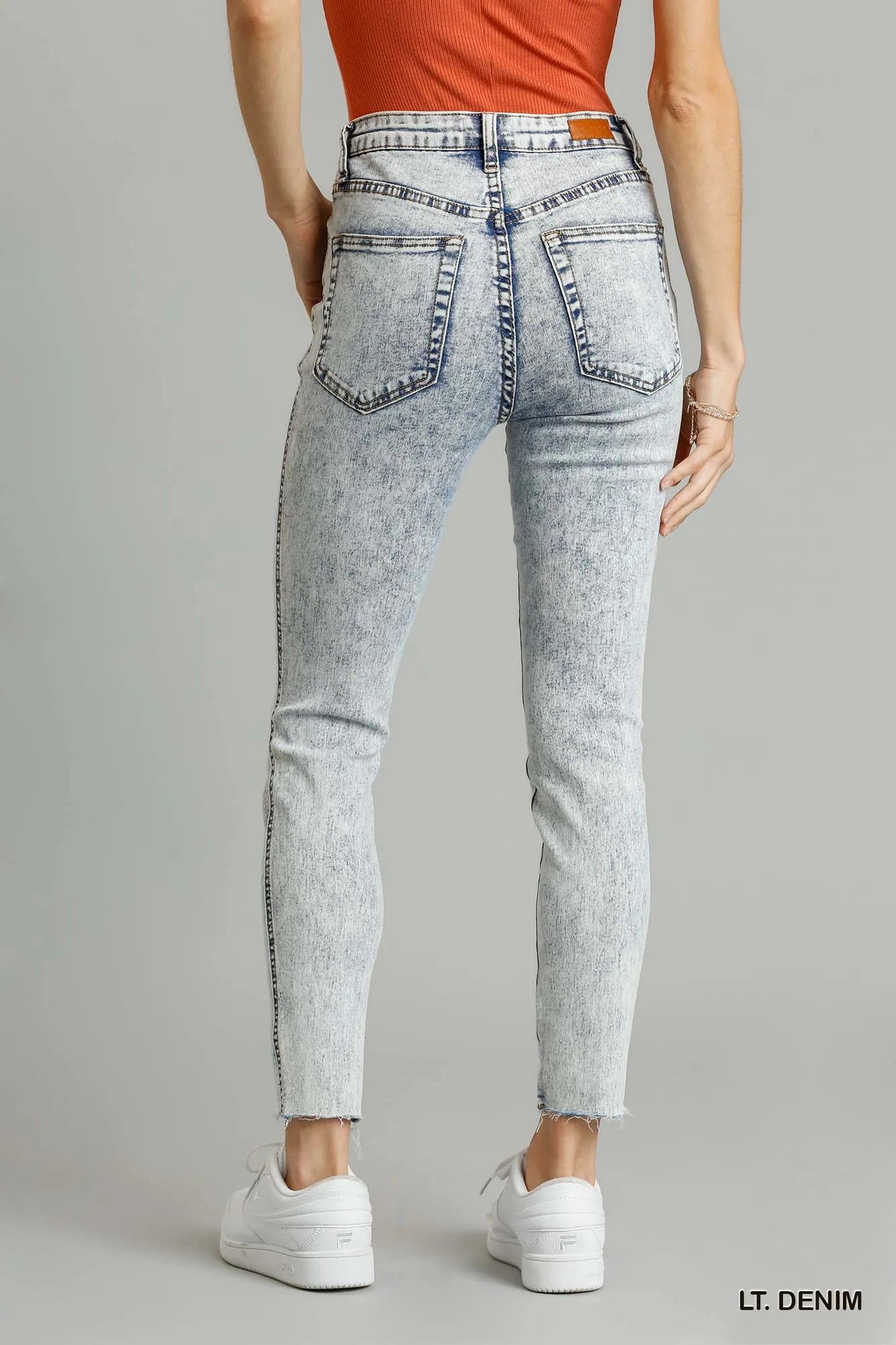 Distressed skinny jeans raw unfinished hem close up
