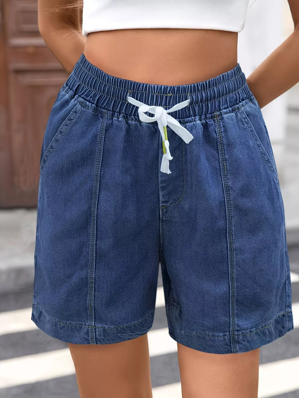 Drawstring waist detail on denim shorts