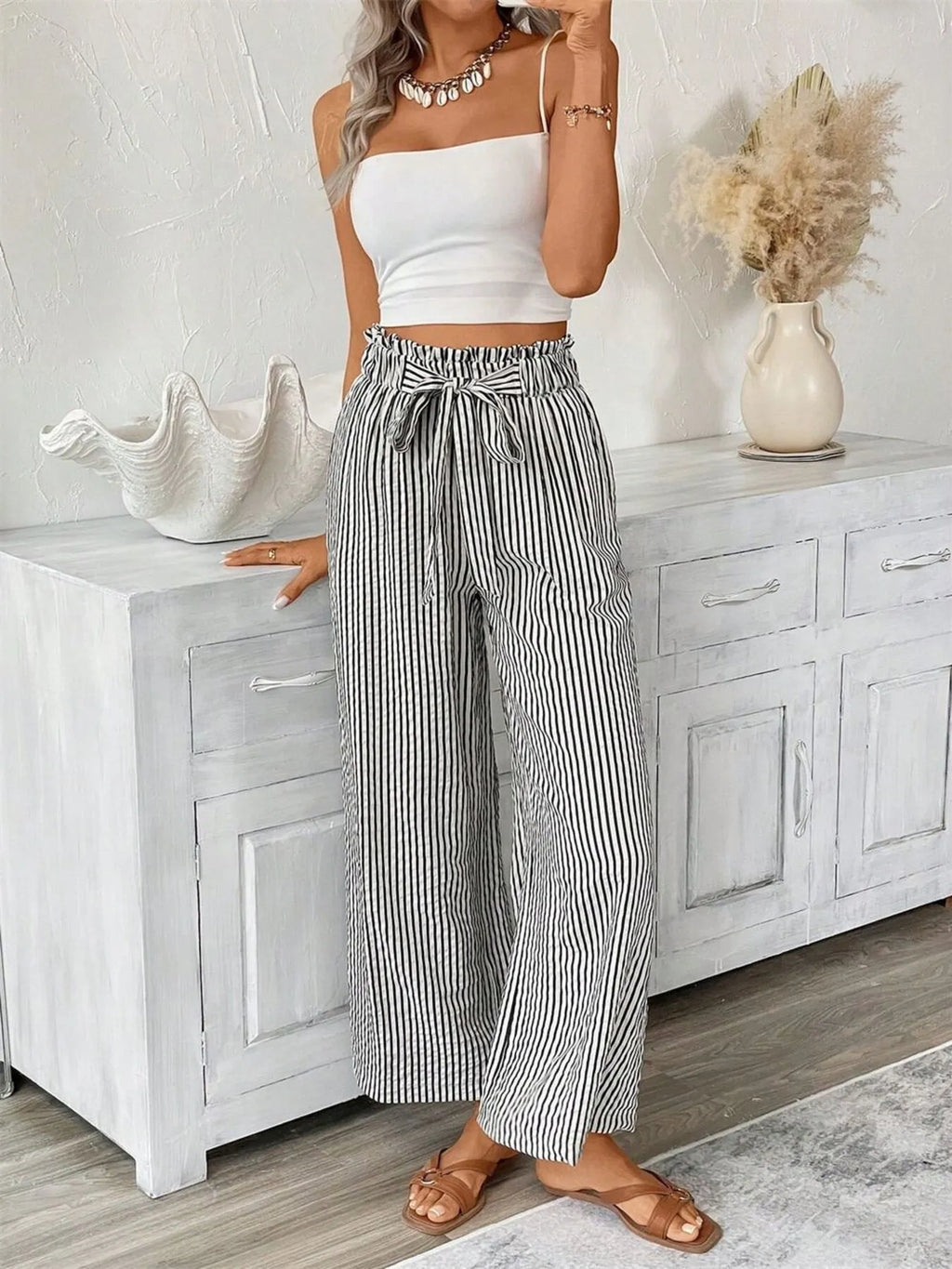 Black wide leg paper bag pants side view on model