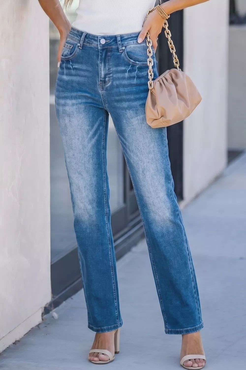 Waistband and pocket detail on acid wash jeans
