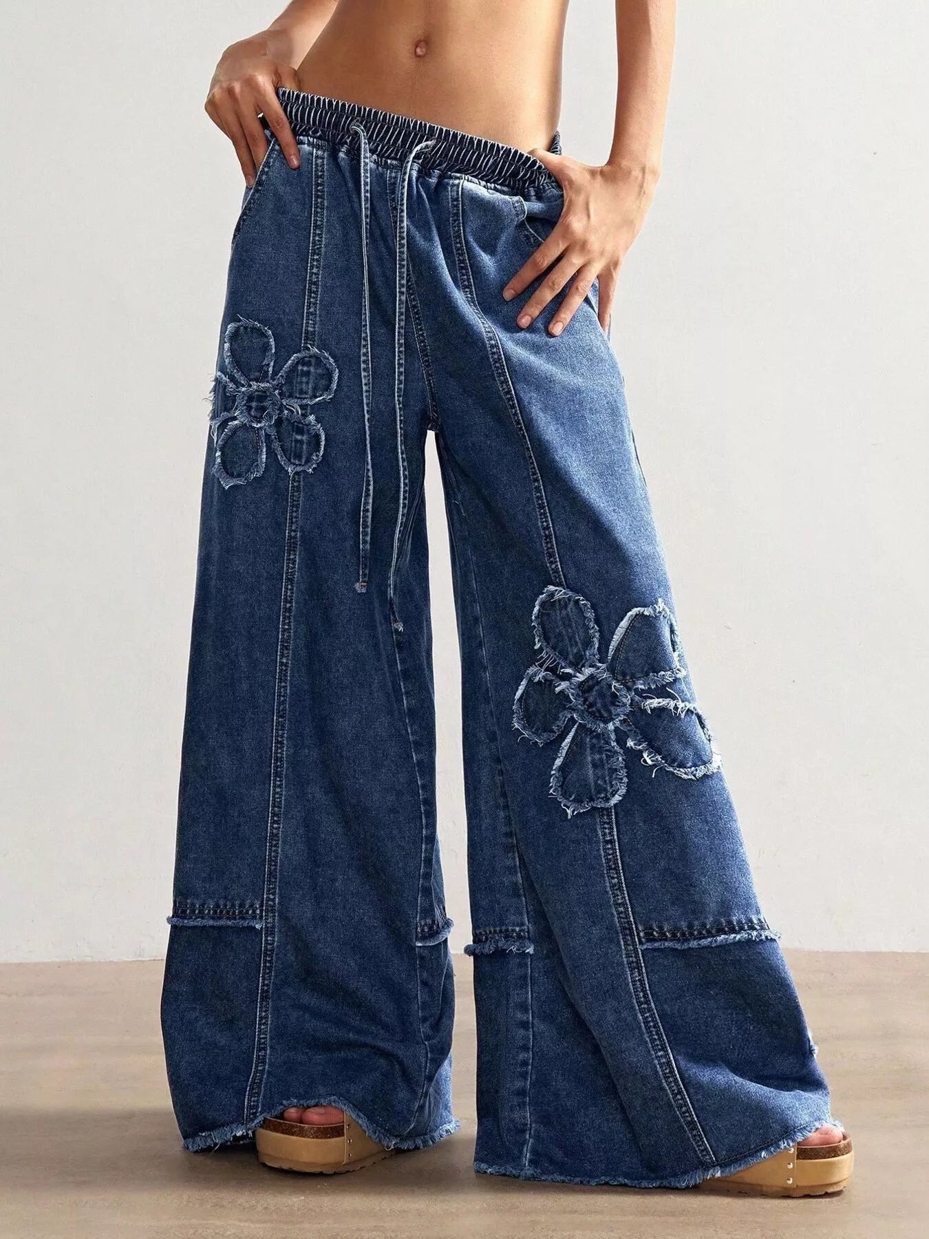 Drawstring waist detail on wide leg jeans