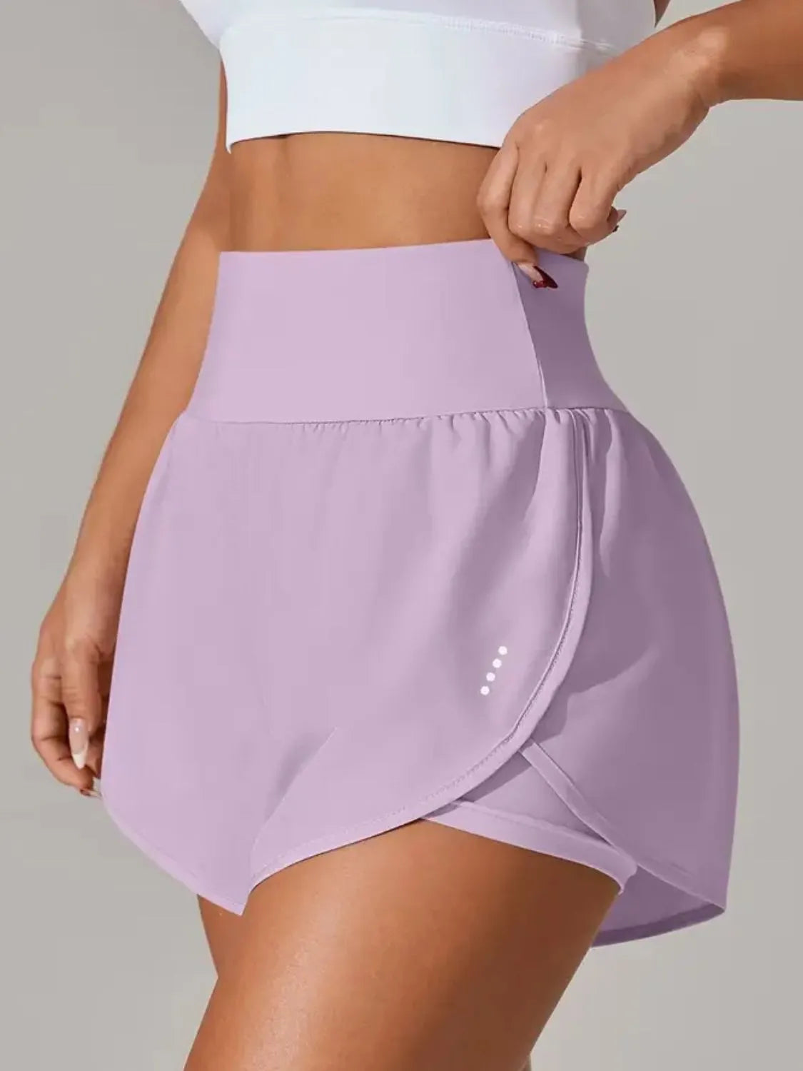 Dusty pink workout shorts side view on model