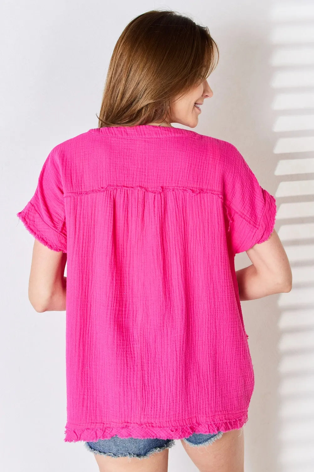 Raw hem short sleeve top side view on model