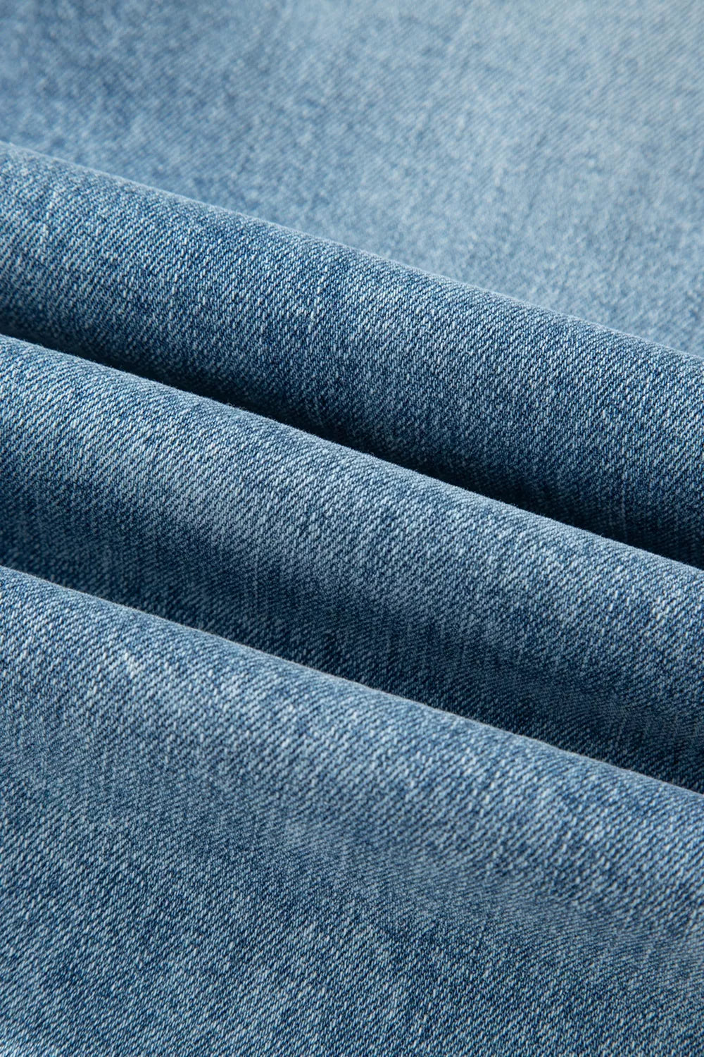Ripped open knee flare jeans walking view